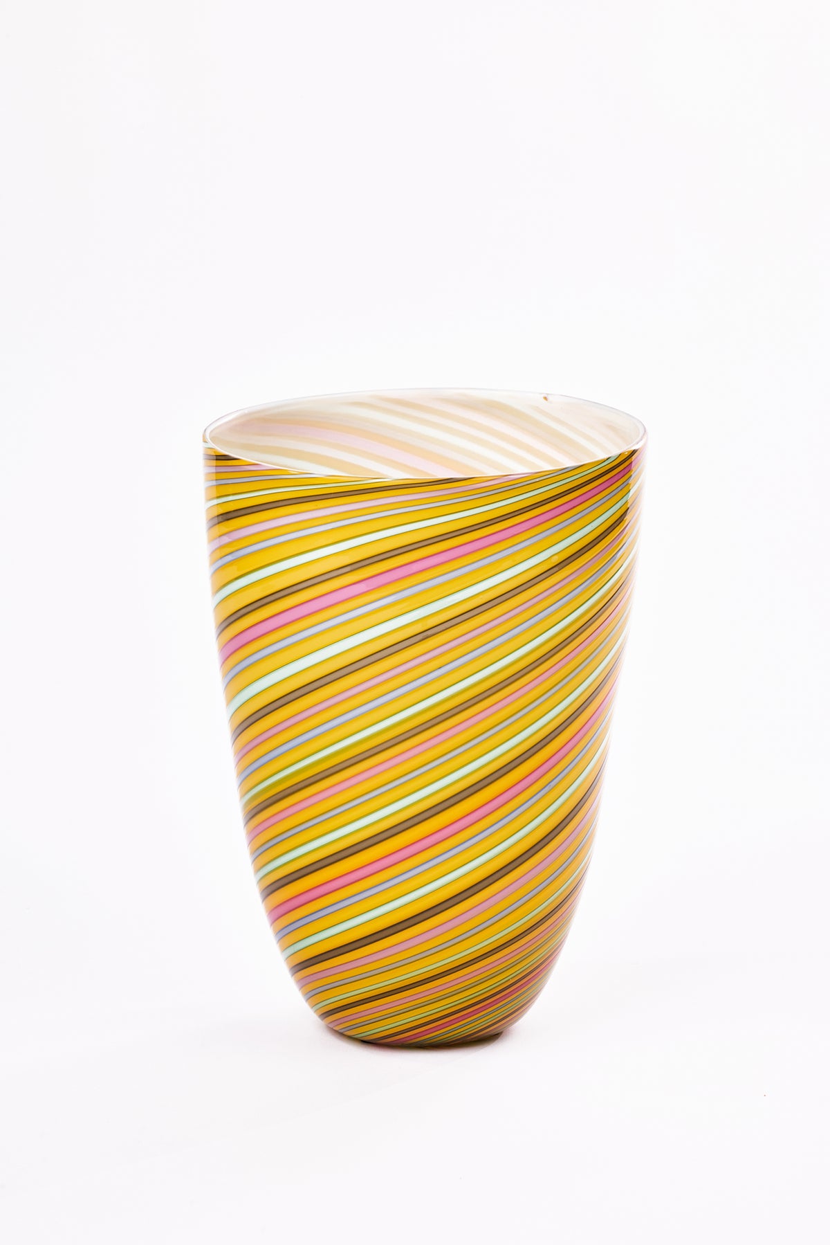 A hand-blown glass vase with a spiral striped pattern in yellow, pink, chocolate, and white, set against a plain white background.