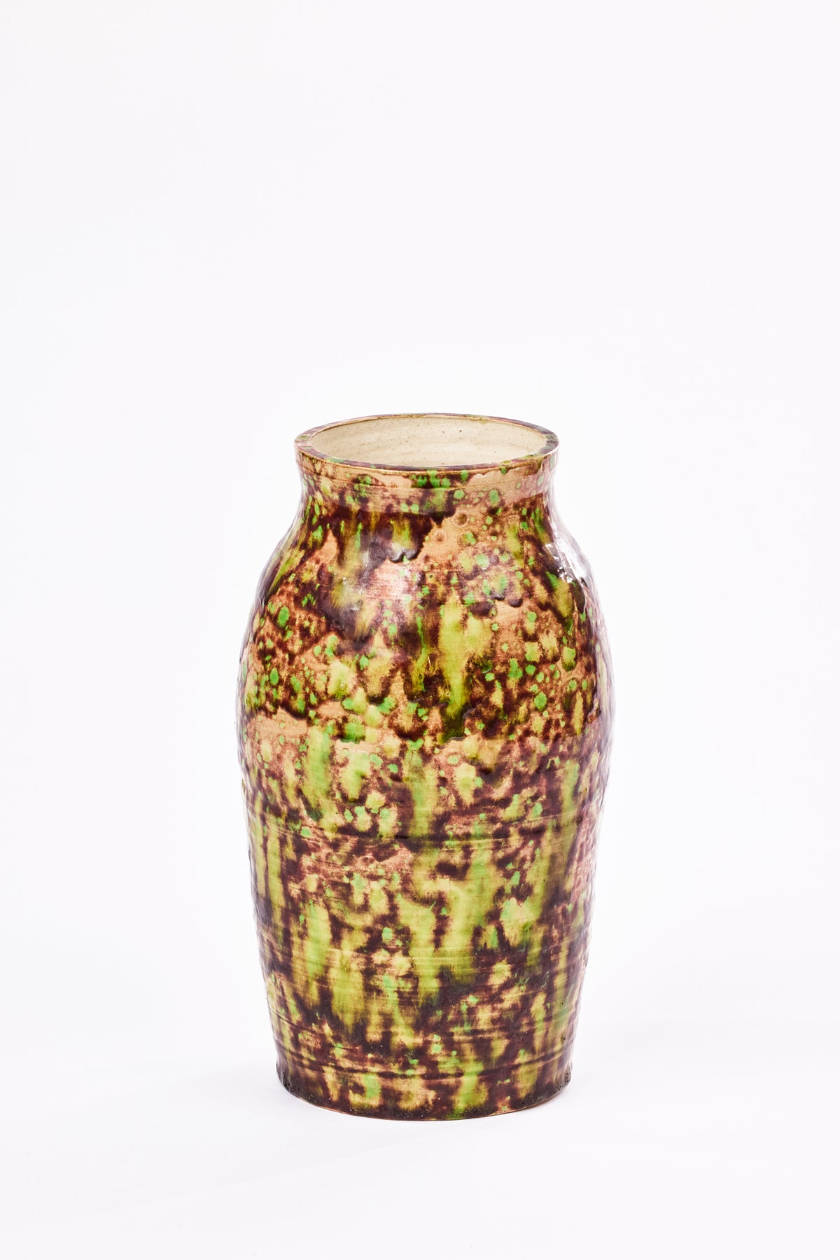 Tall ceramic vase with rounded shoulders, a narrow neck and a mottled glaze in vivid green, earthy brown and tan, photographed against a white background.