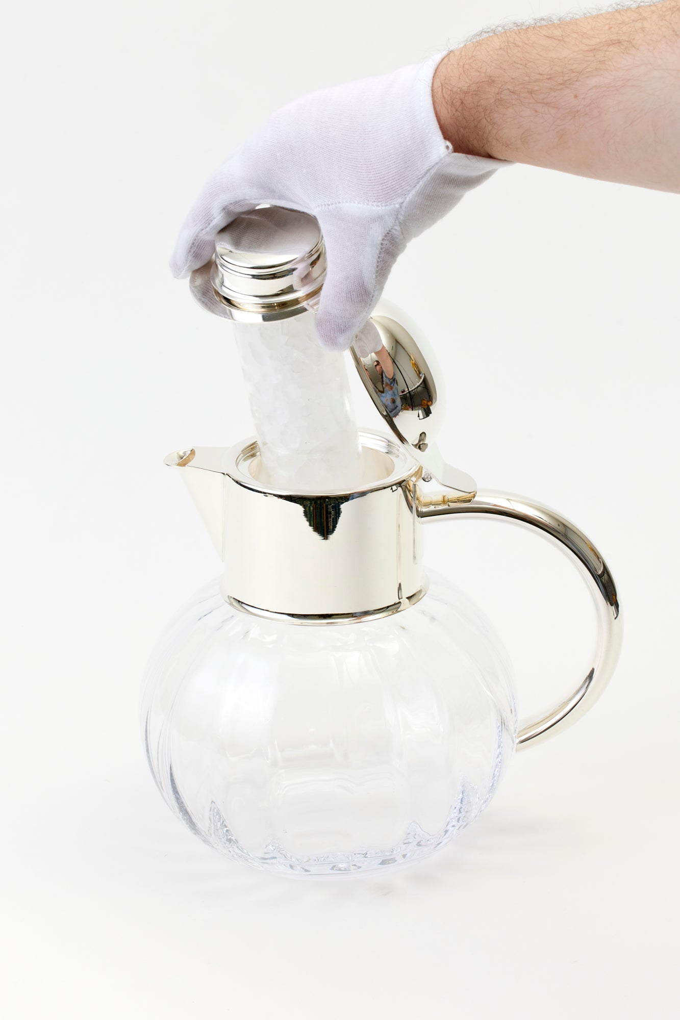 Ice beverage pitcher. Silver-plated top with a crystal body.