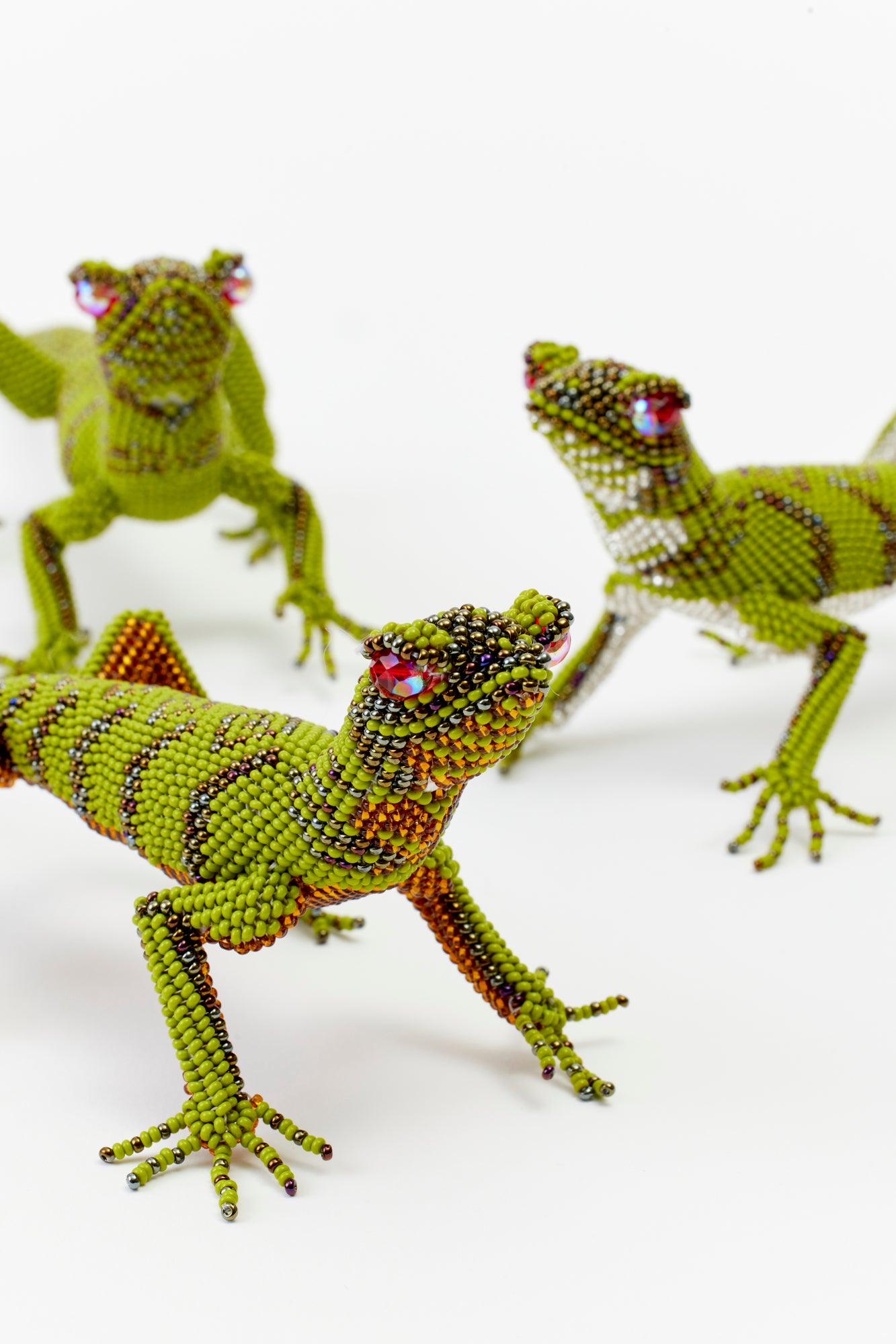 Hand beaded lizard figurines.