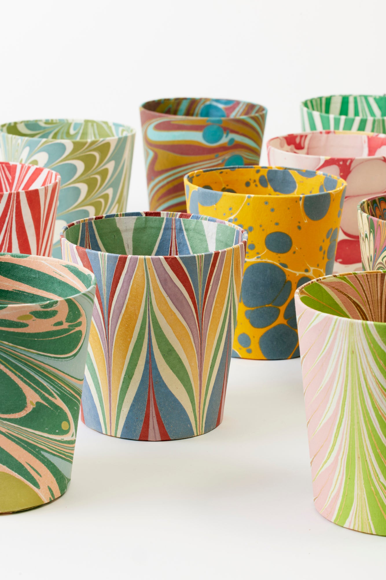 Artisan paper-covered cachepots with a plastic liner. Made to fit pots of standard seasonal bulbs or orchids.