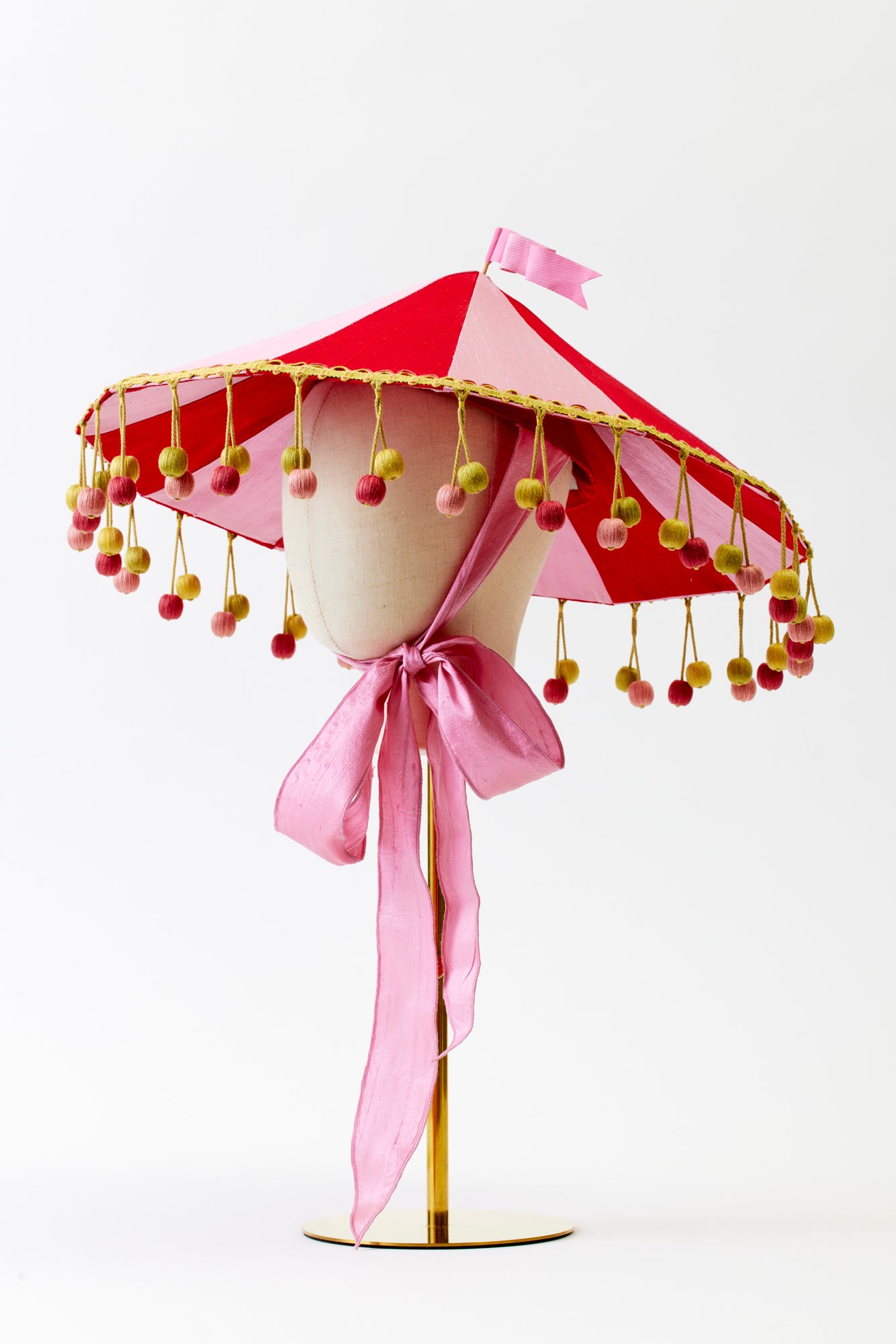 Pink and red circus hat resembling a circus tent.