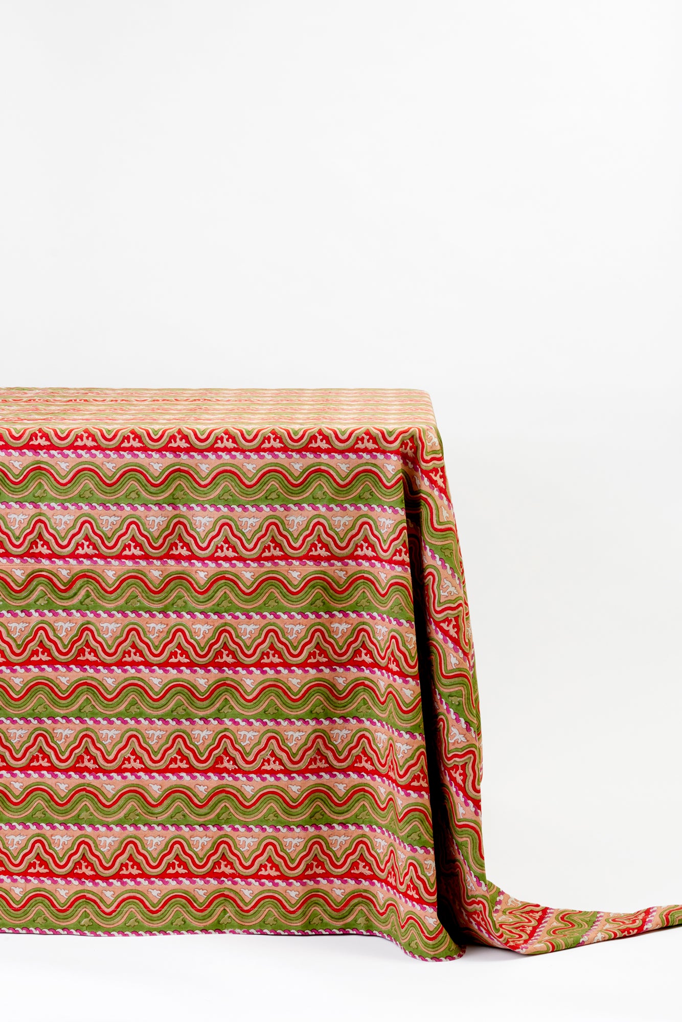 Mexican waves Christmas tablecloth, draped on a table against a white background.