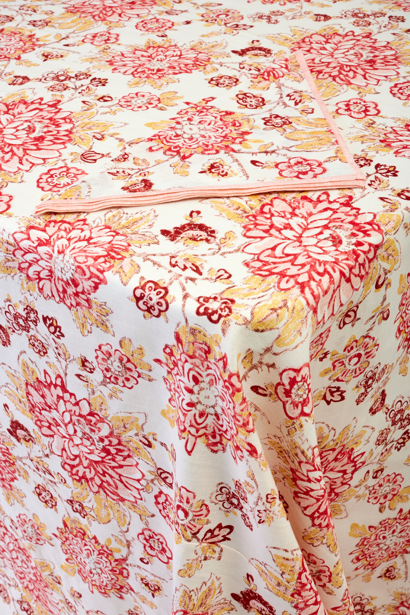 Spicy red and pink floral tablecloth to the floor.