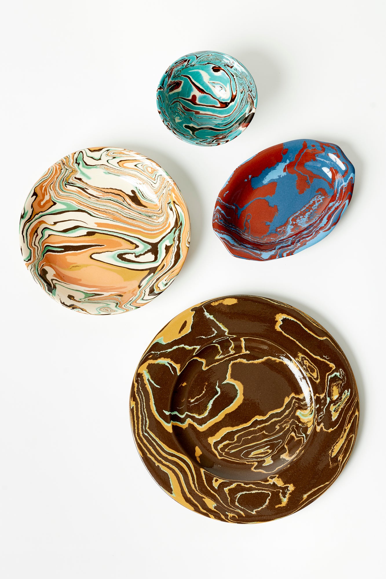 4 marbled ceramic dishes on a white background. 