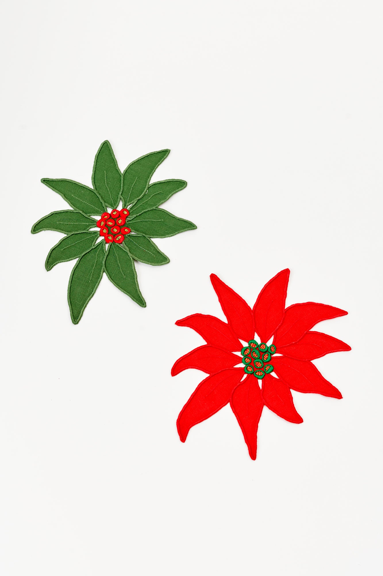 Set of four embroidered linen poinsettia red and green Christmas cocktail napkins made in Madeira, Portugal.