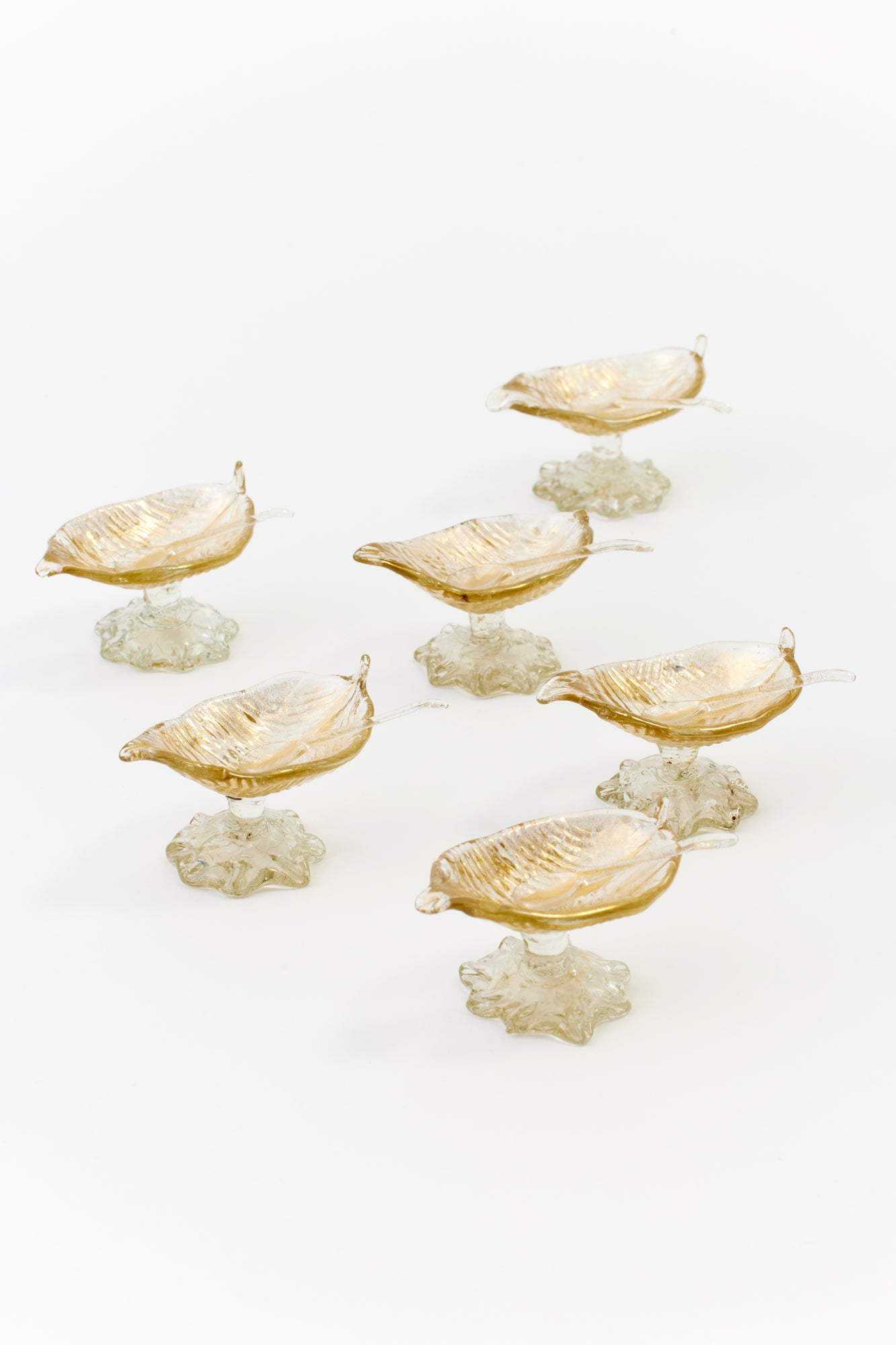 Vintage gold glimmering Venetian footed salts with teeny tiny spoons.