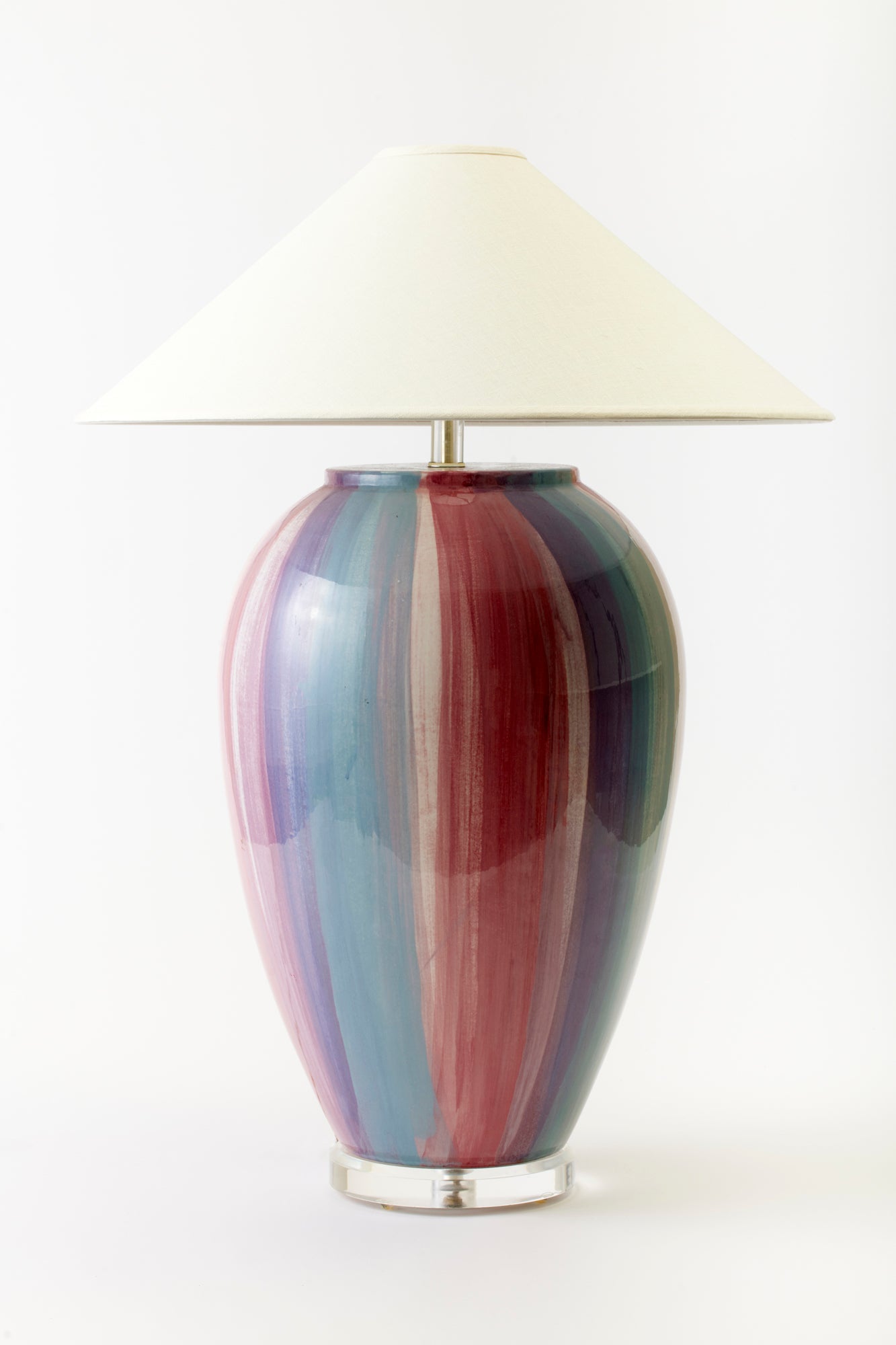 Large red and blue glass lamp base and white lampshade.