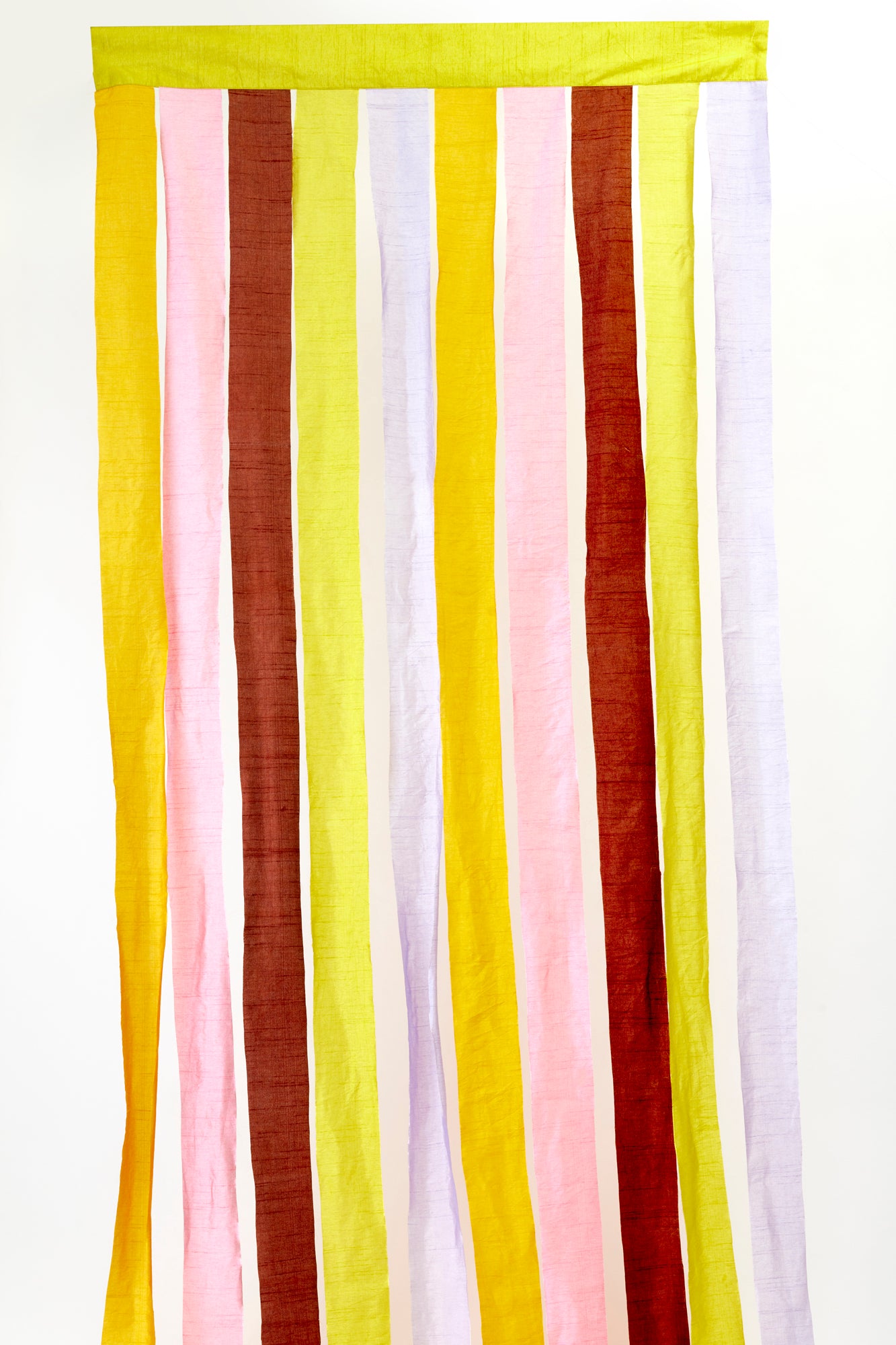 Vibrant drapes with alternating stripes of yellow, pink, brown, and white fabric, creating a playful, colorful backdrop. Perfect for adding a lively, modern touch to festive gatherings or creative decor settings.