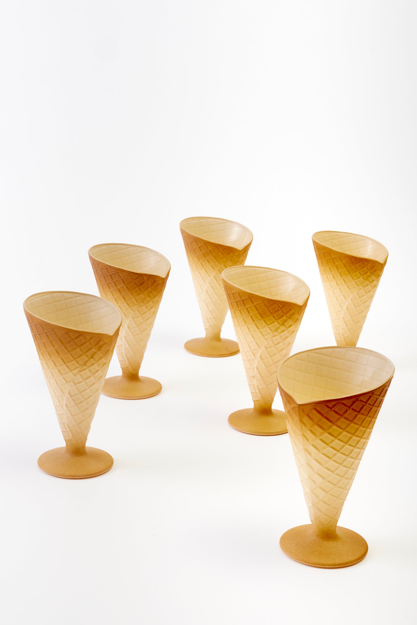 Set of six tan-colored cups shaped like ice cream cones with a waffle pattern.