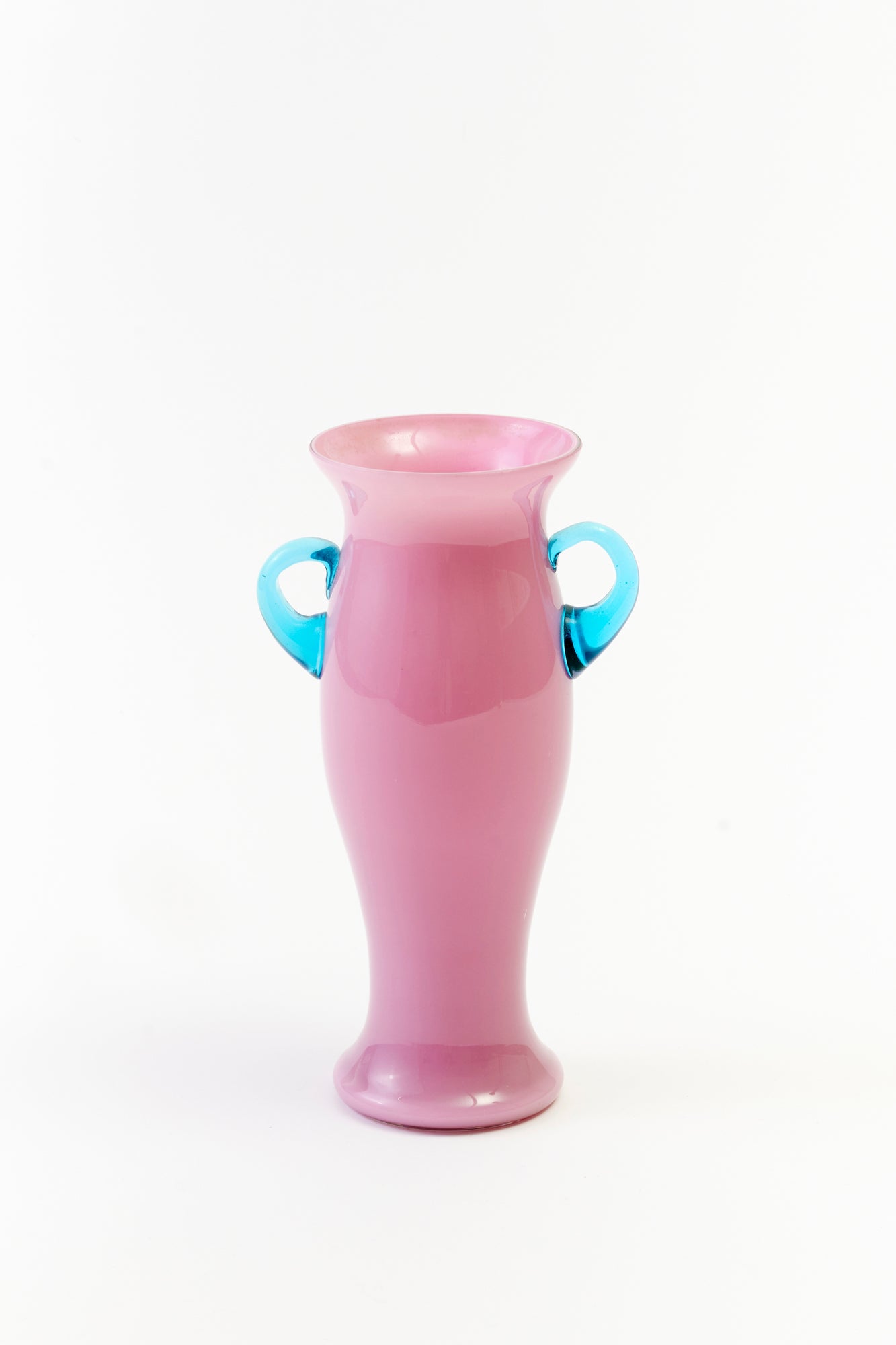 Vintage pink glass vase with blue handles.