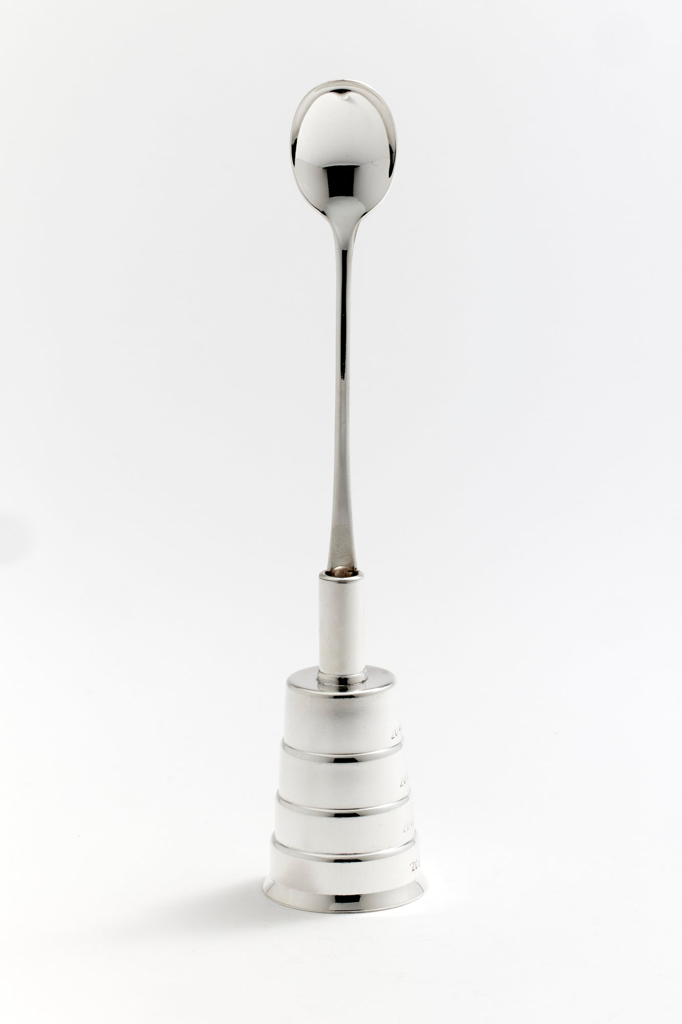 Tall silver jigger spoon with a beehive shaped base, featuring marked measurements. Perfect for your bar.