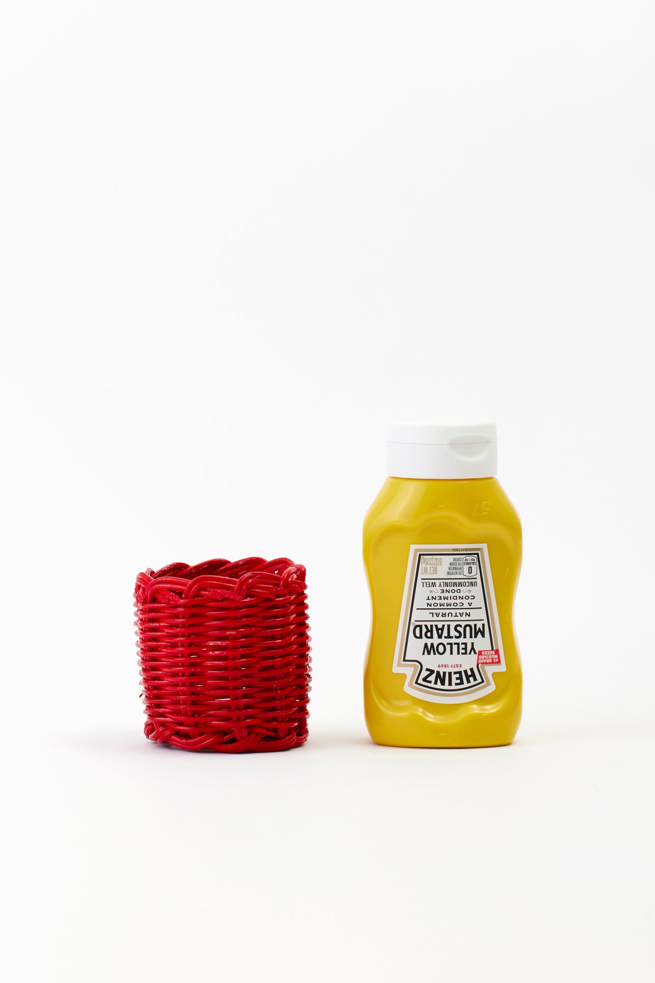 Red wicker condiment cover for mustard.