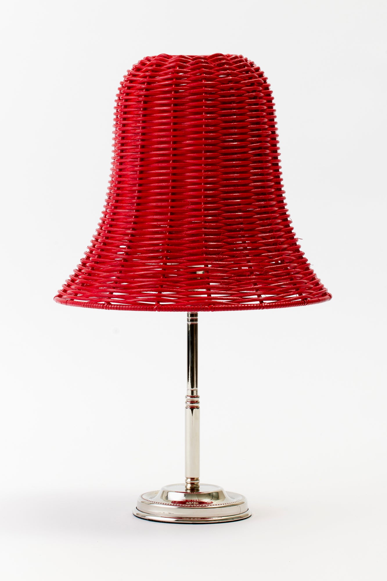 Red wicker table lamp shade shaped like a bell.