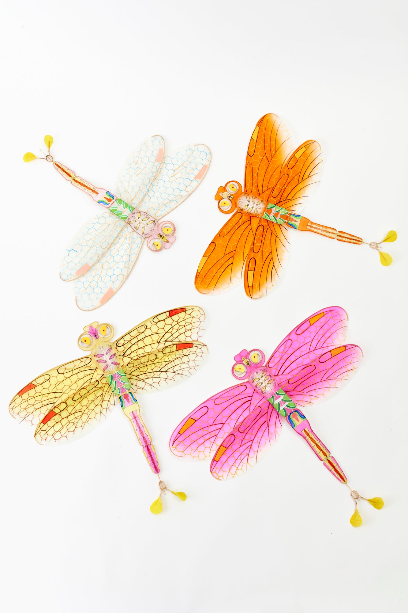 Dragonfly kite in orange, pink, clear, and yellow. Perfect for parties.