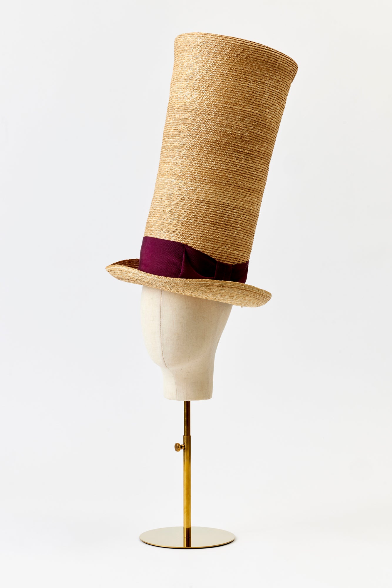 Straw top hat that is tall to the ceiling.