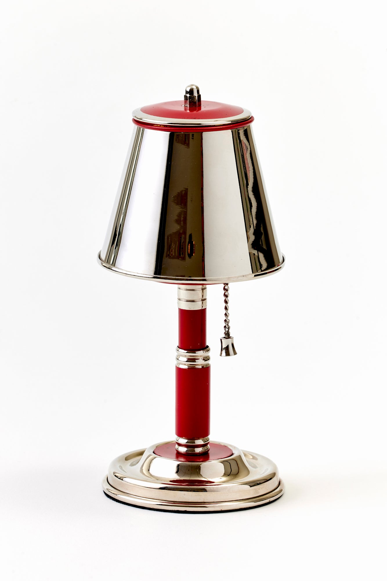 Decorative cigarette dispenser with red and silver design on a white background