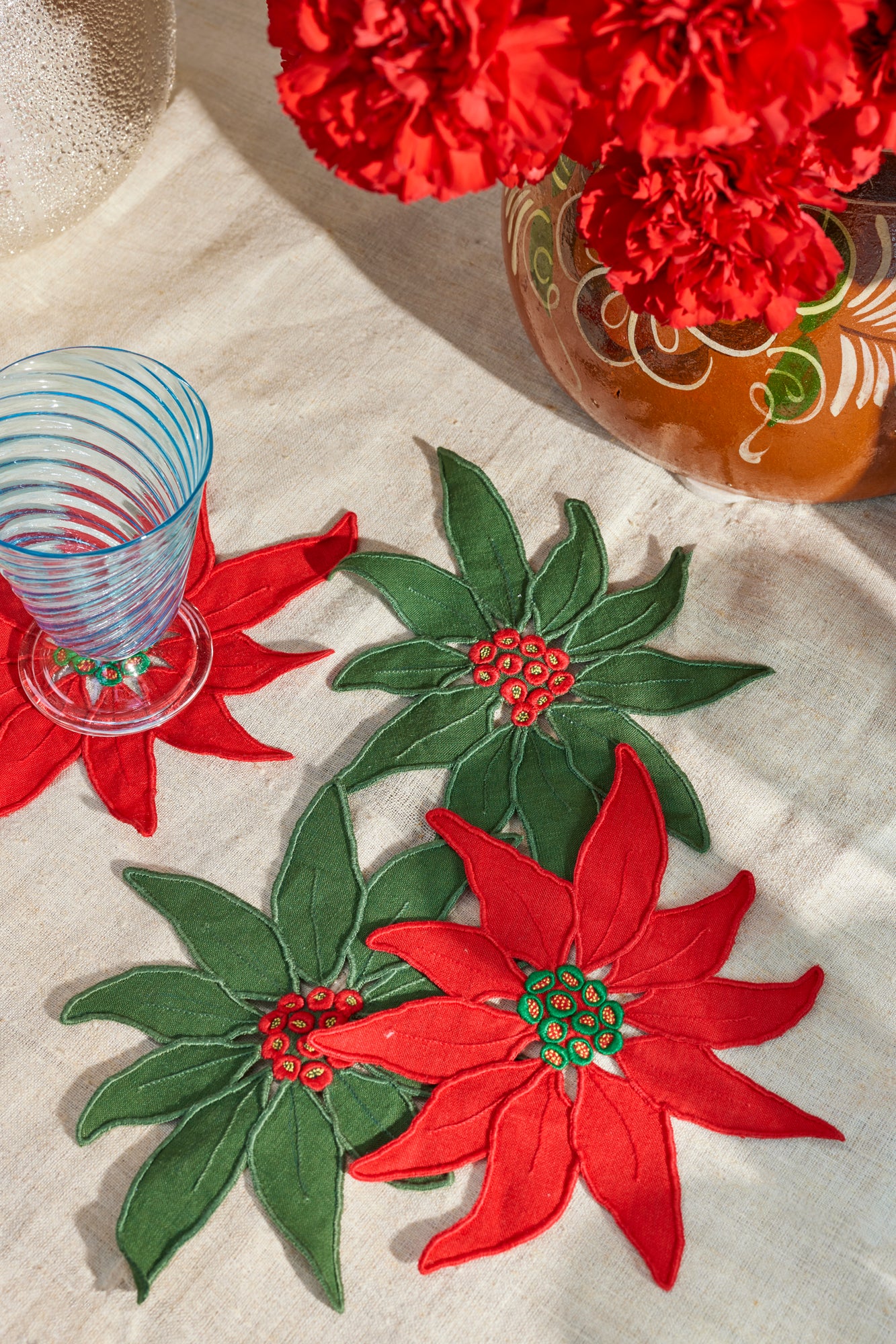 Set of four embroidered linen poinsettia red and green Christmas cocktail napkins made in Madeira, Portugal.