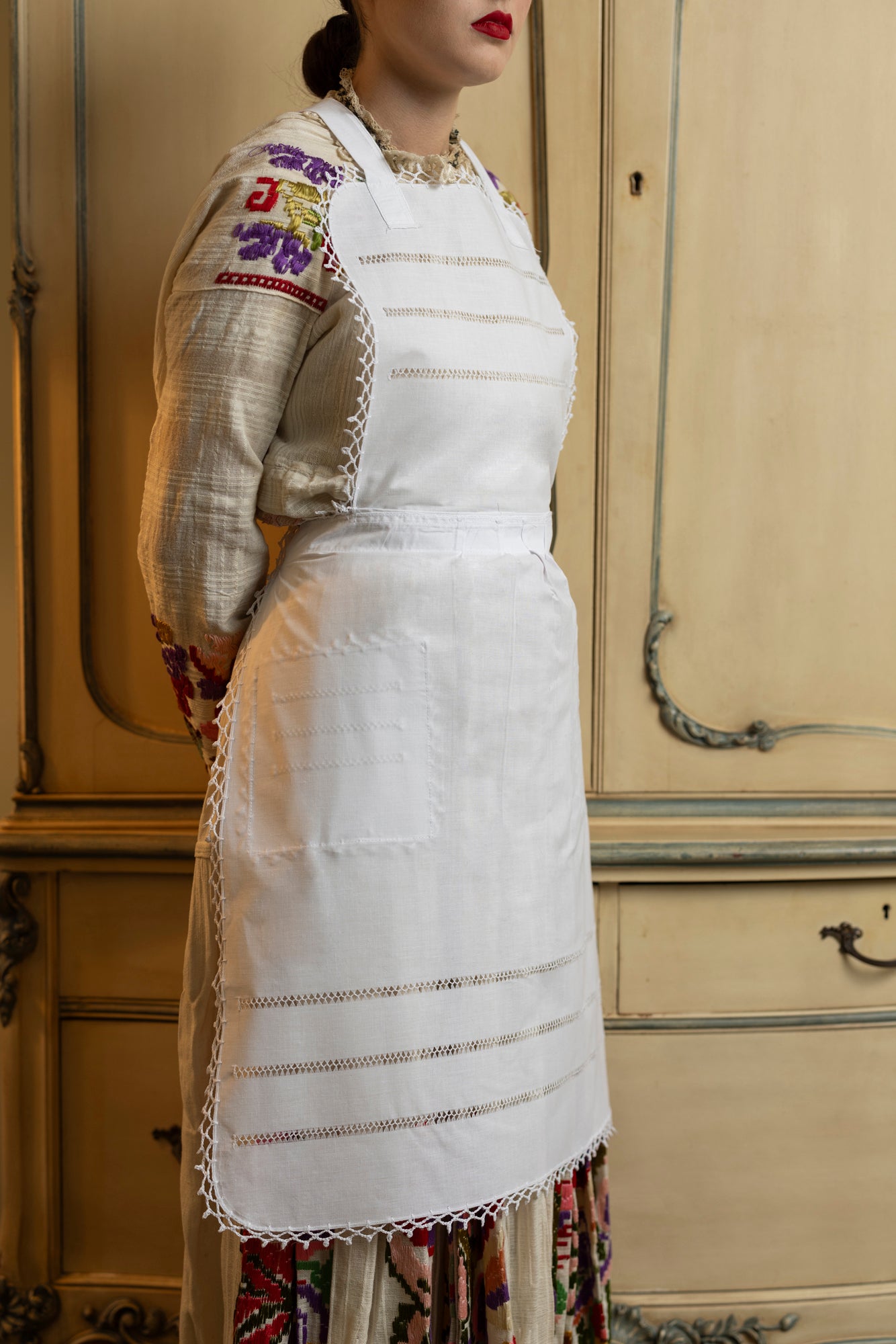 Embroidered white apron.