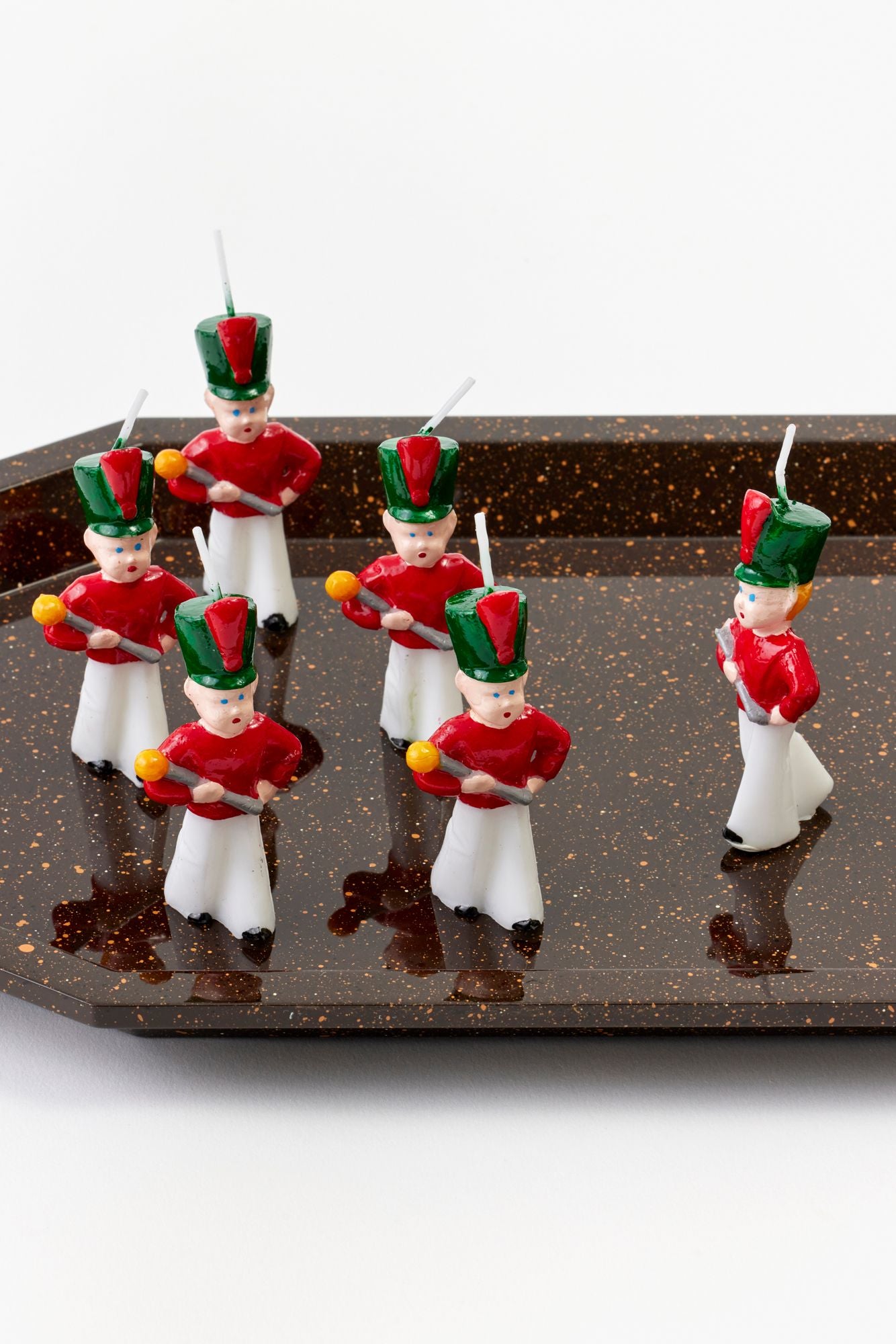 Marcher boy candles on a tray.