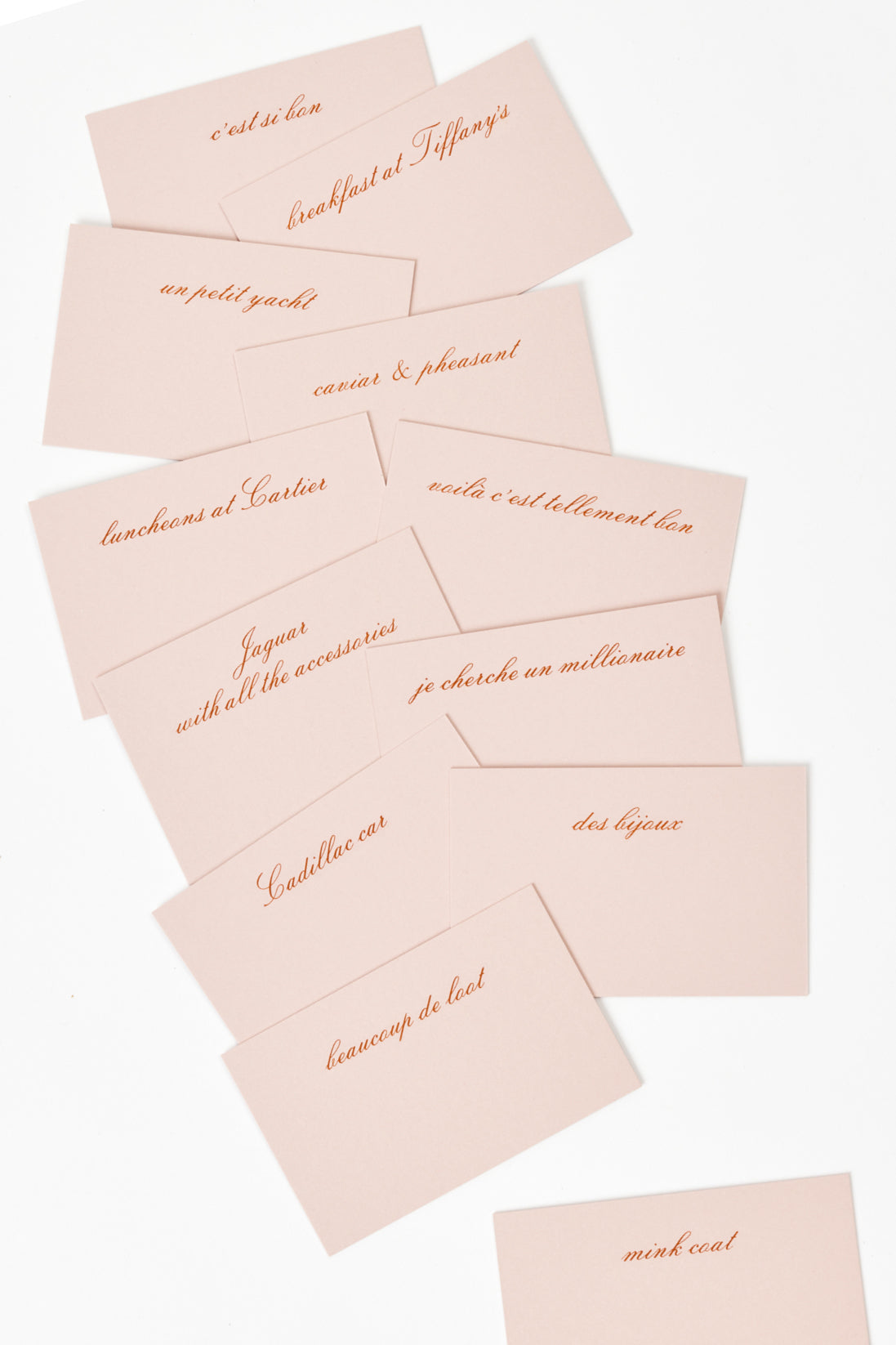 A set of 12 engraved place cards proclaiming the meaning of Champagne life, according to Eartha Kitt.