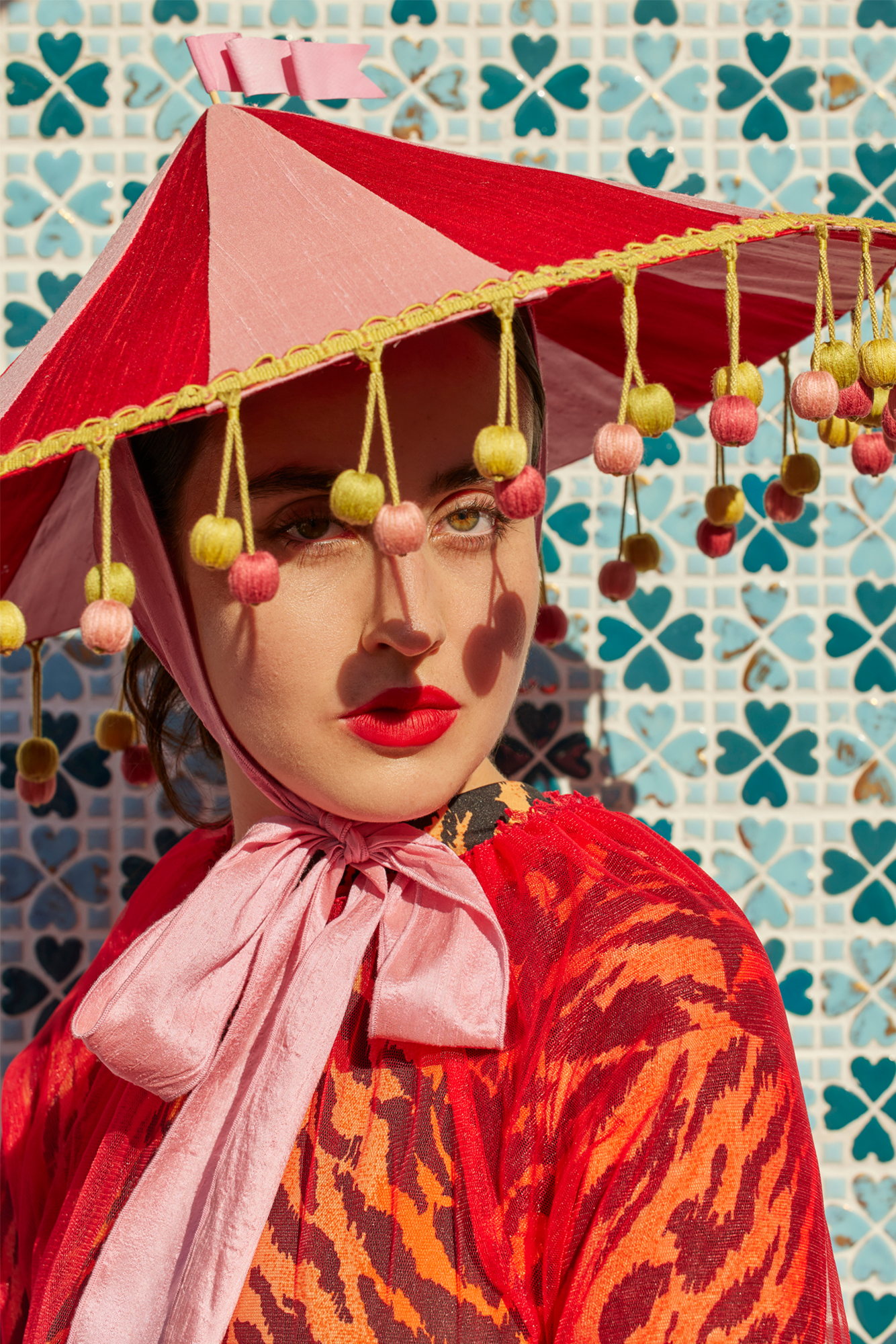 Pink and red circus hat resembling a circus tent.