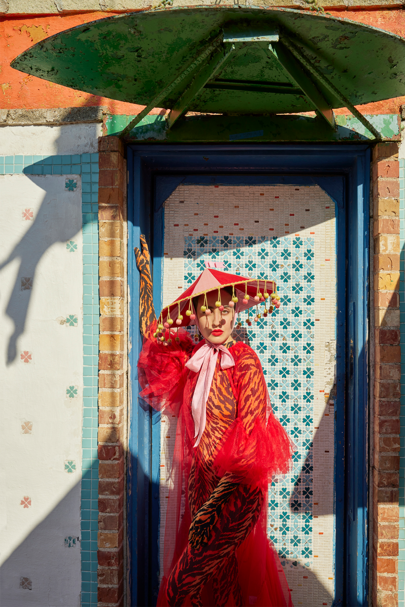 Pink and red circus hat resembling a circus tent.