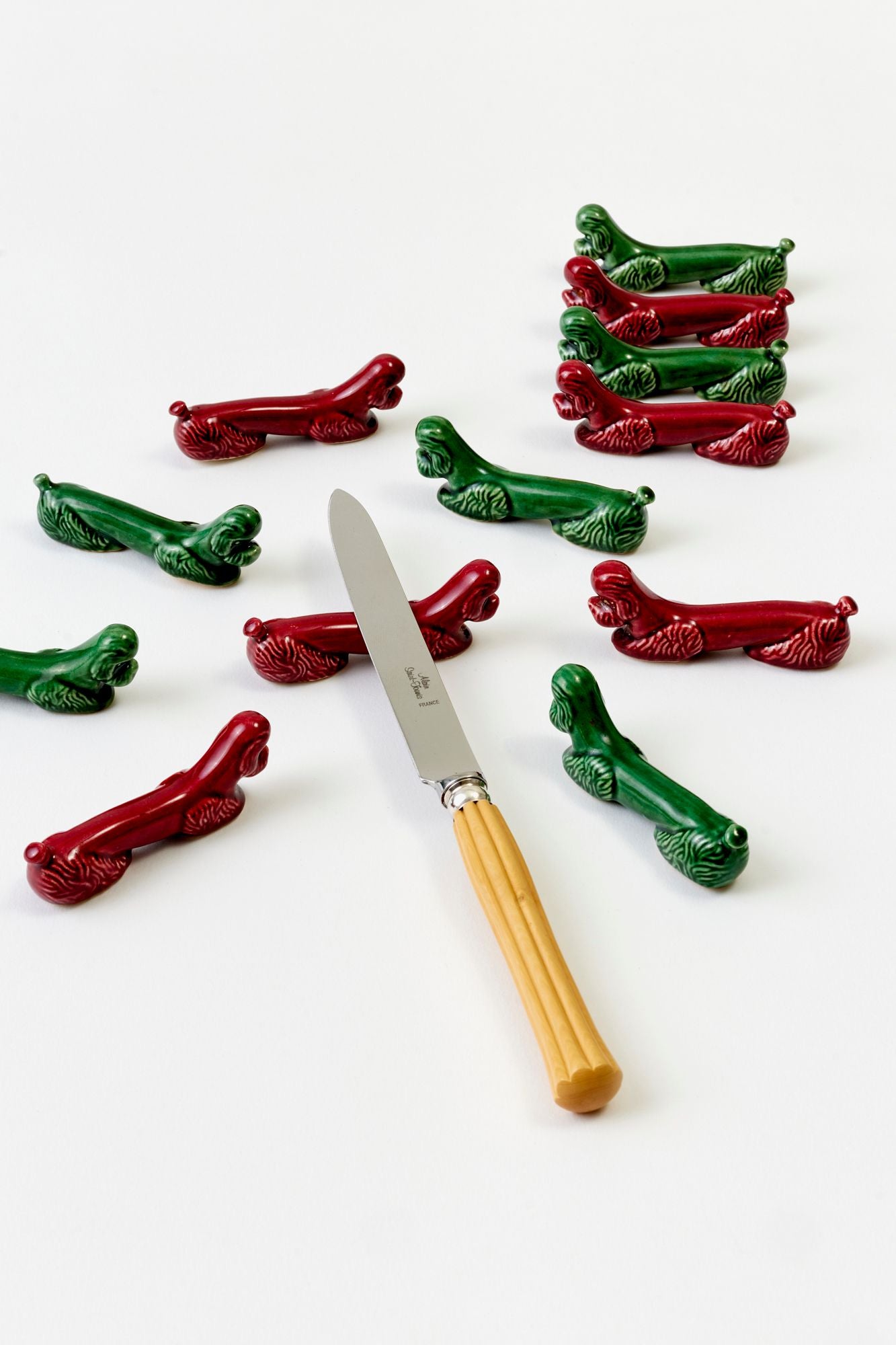 SET OF 12 VINTAGE FRENCH MAJOLICA POODLE KNIFE RESTS.