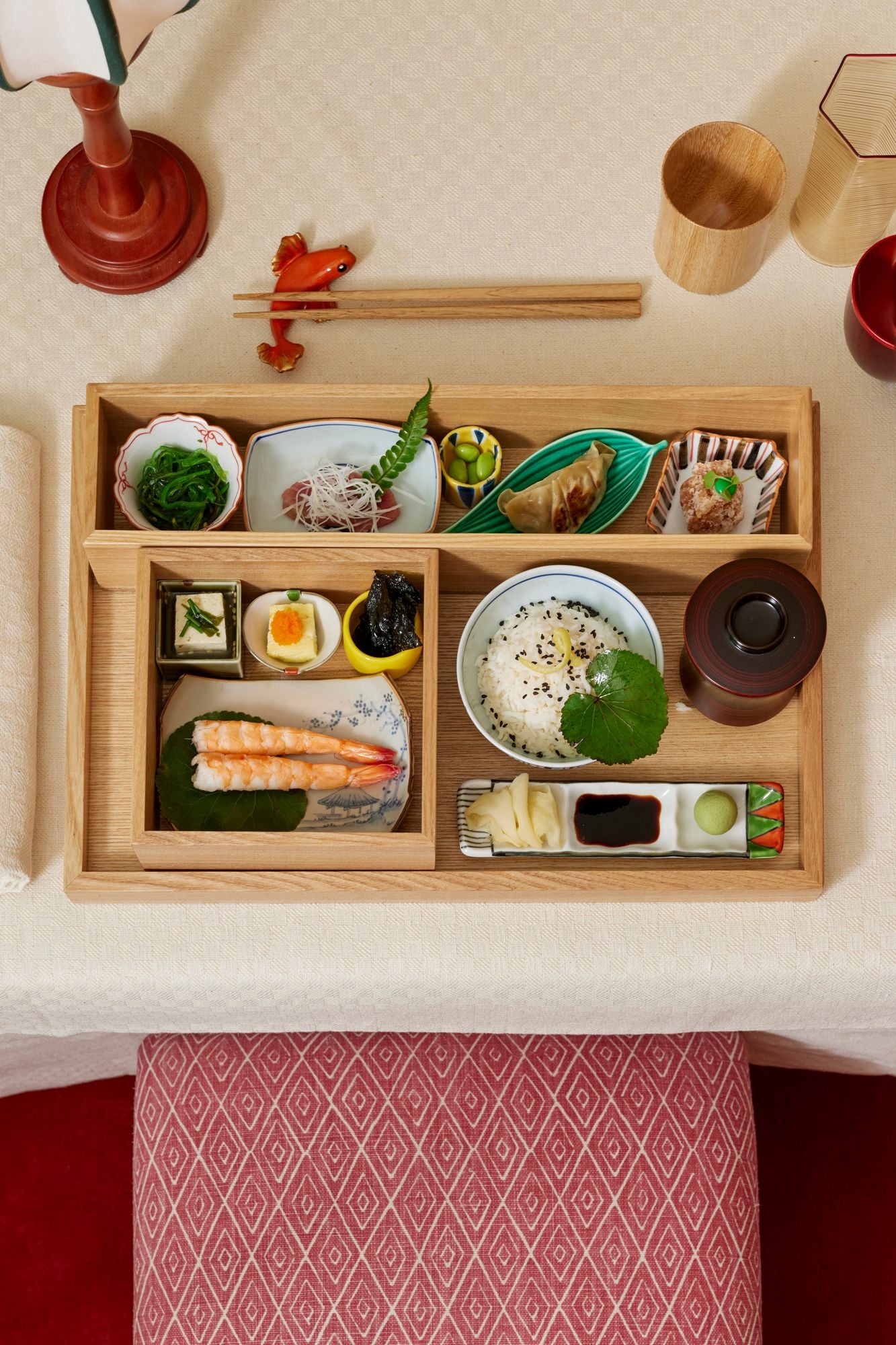 Wood bento box with Japanese meal on a white tablecloth