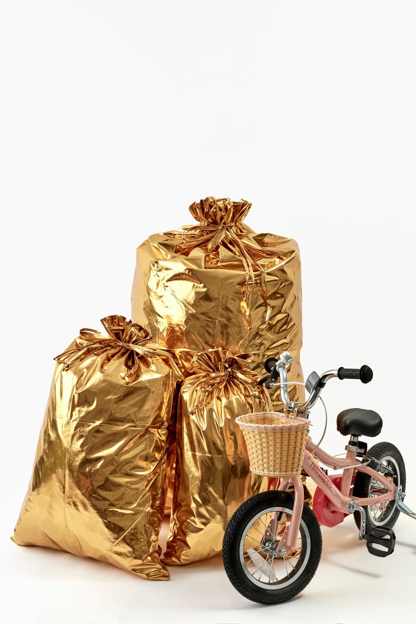 Gold gift bags with a pink bicycle on a white background