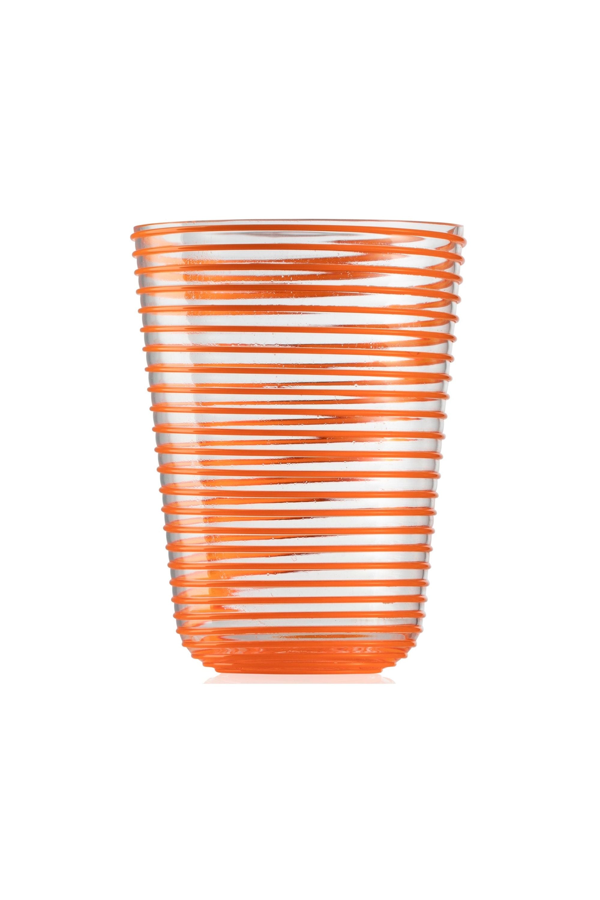 Transparent glass embossed with orange glass thread spiraling up the cup.