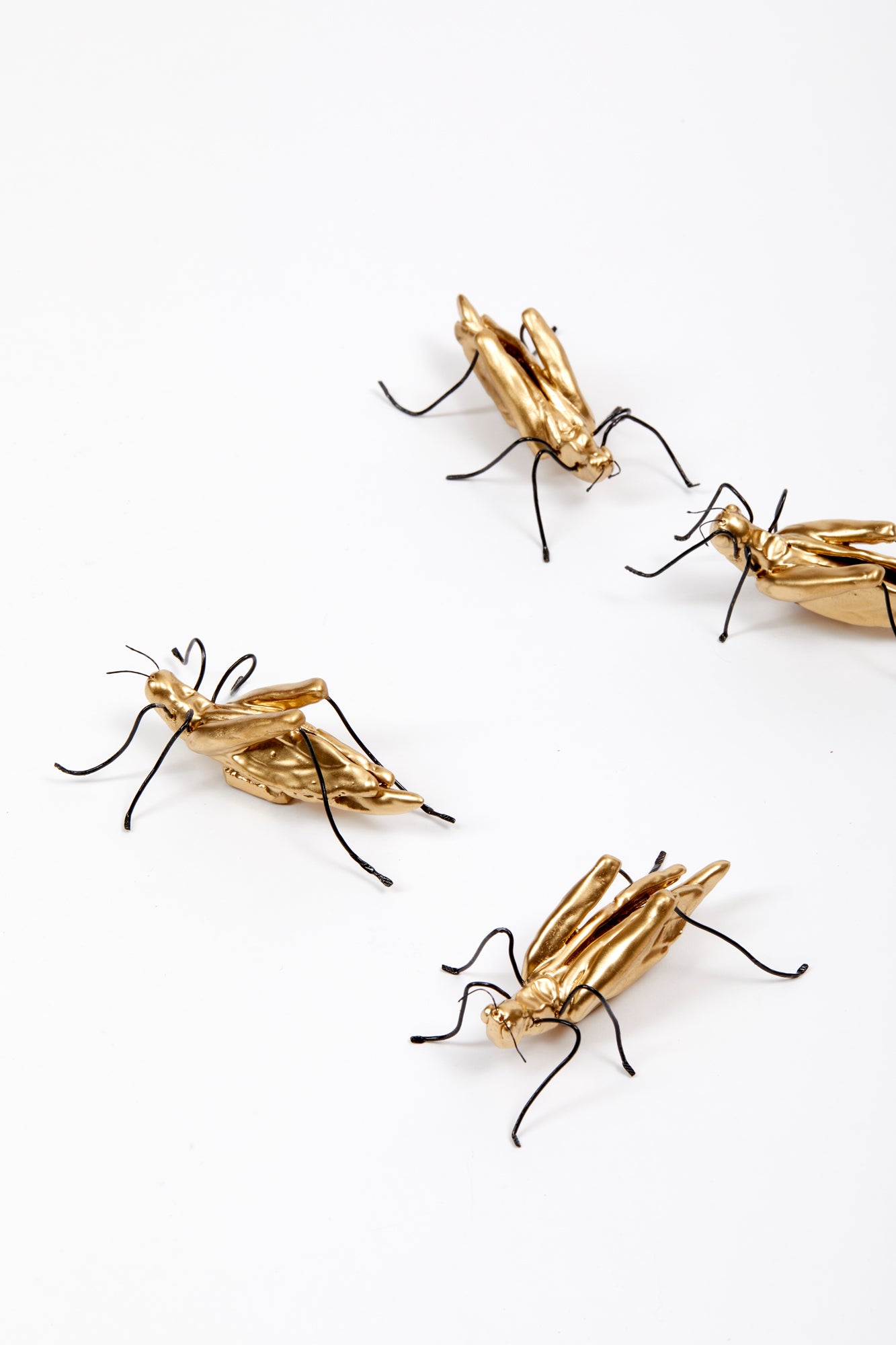 Handmade ceramic gold crickets.