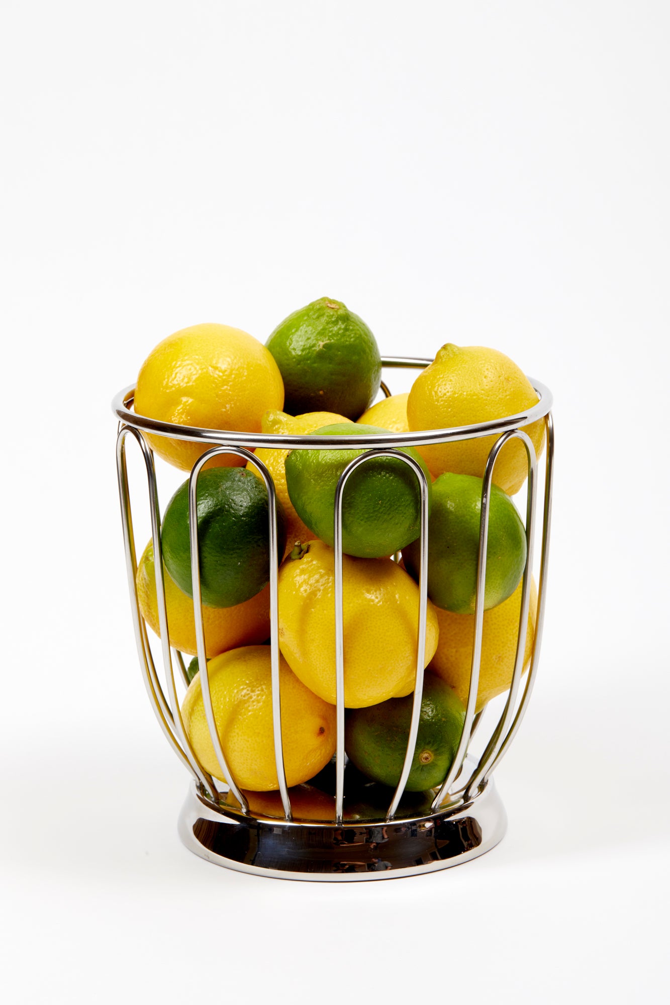 This metal wire basket was designed for lightness and function, the basket can be used to corral citrus on a bar or mixed fruit.