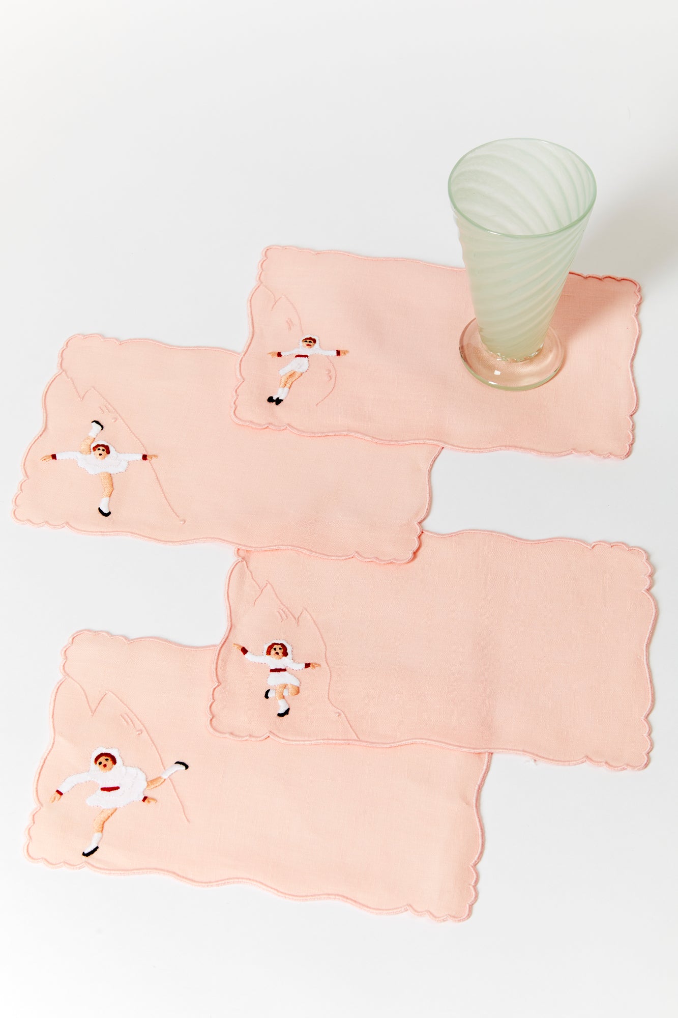 A set of 4 cocktail napkins with appliqué ice skaters made in Madeira, Portugal