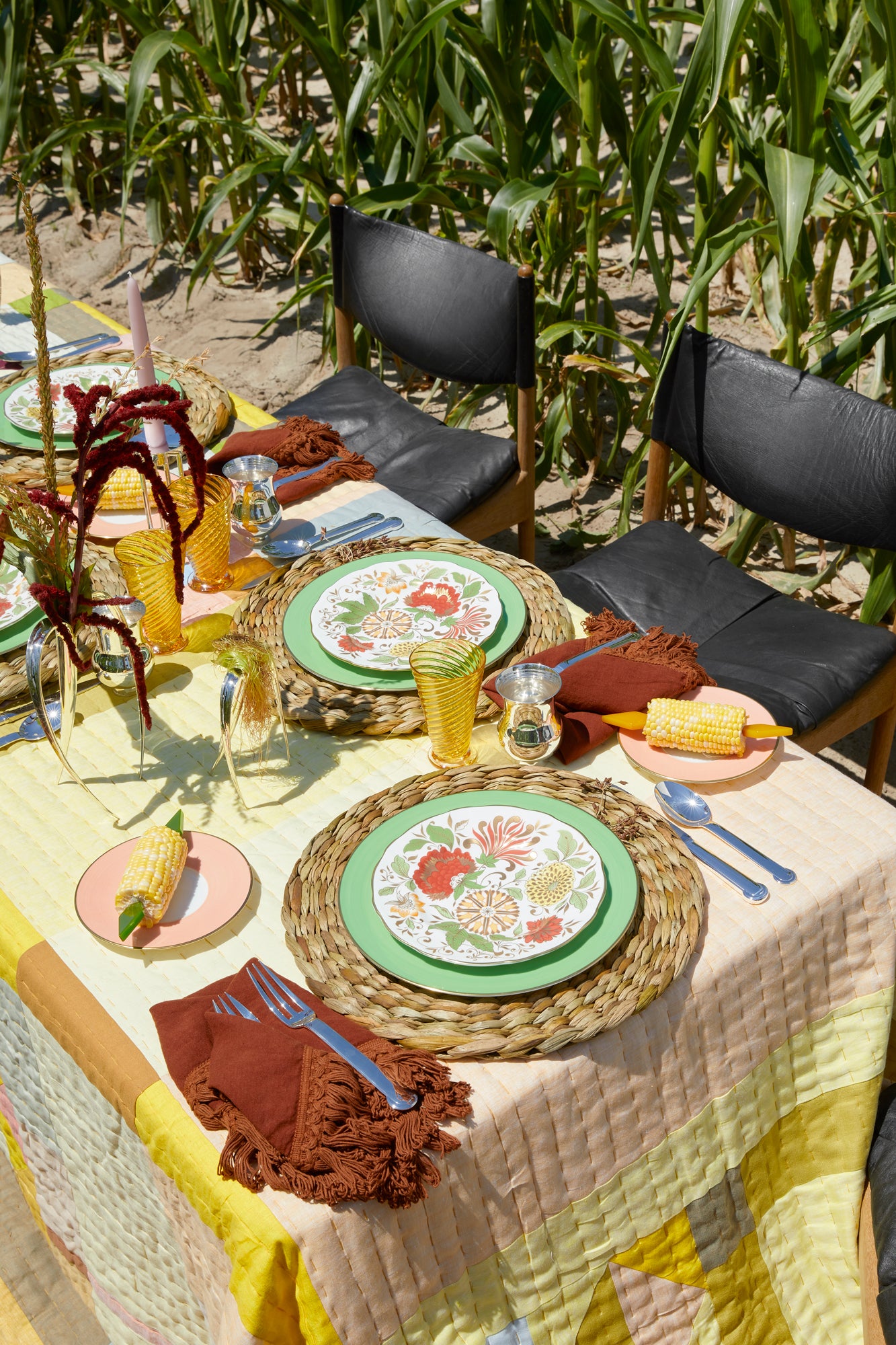 Photograph of a table setting outside against a corn field.