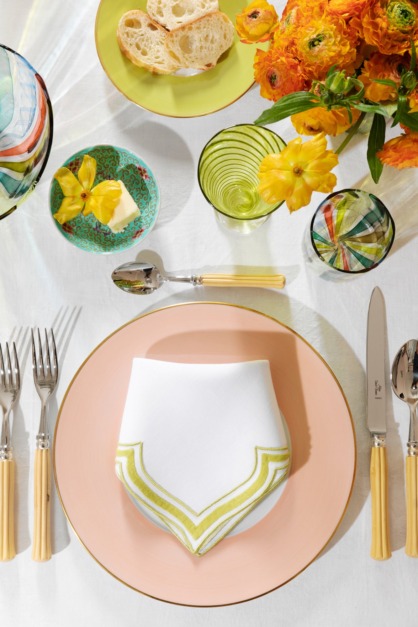 Linen dinner napkin in an unusual scalloped design with chartreuse embroidery and French stitch appliqué made in Madeira, Portugal.