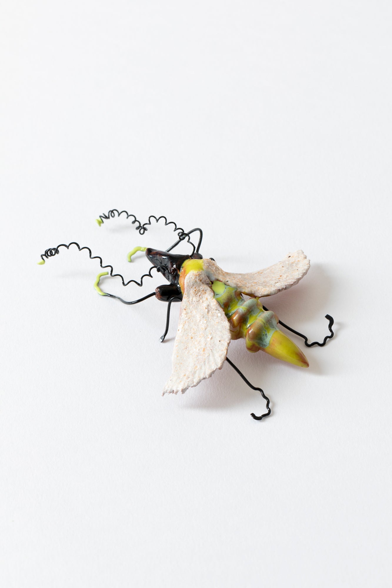 Handmade ceramic insects in various shapes, glazes, and guises.