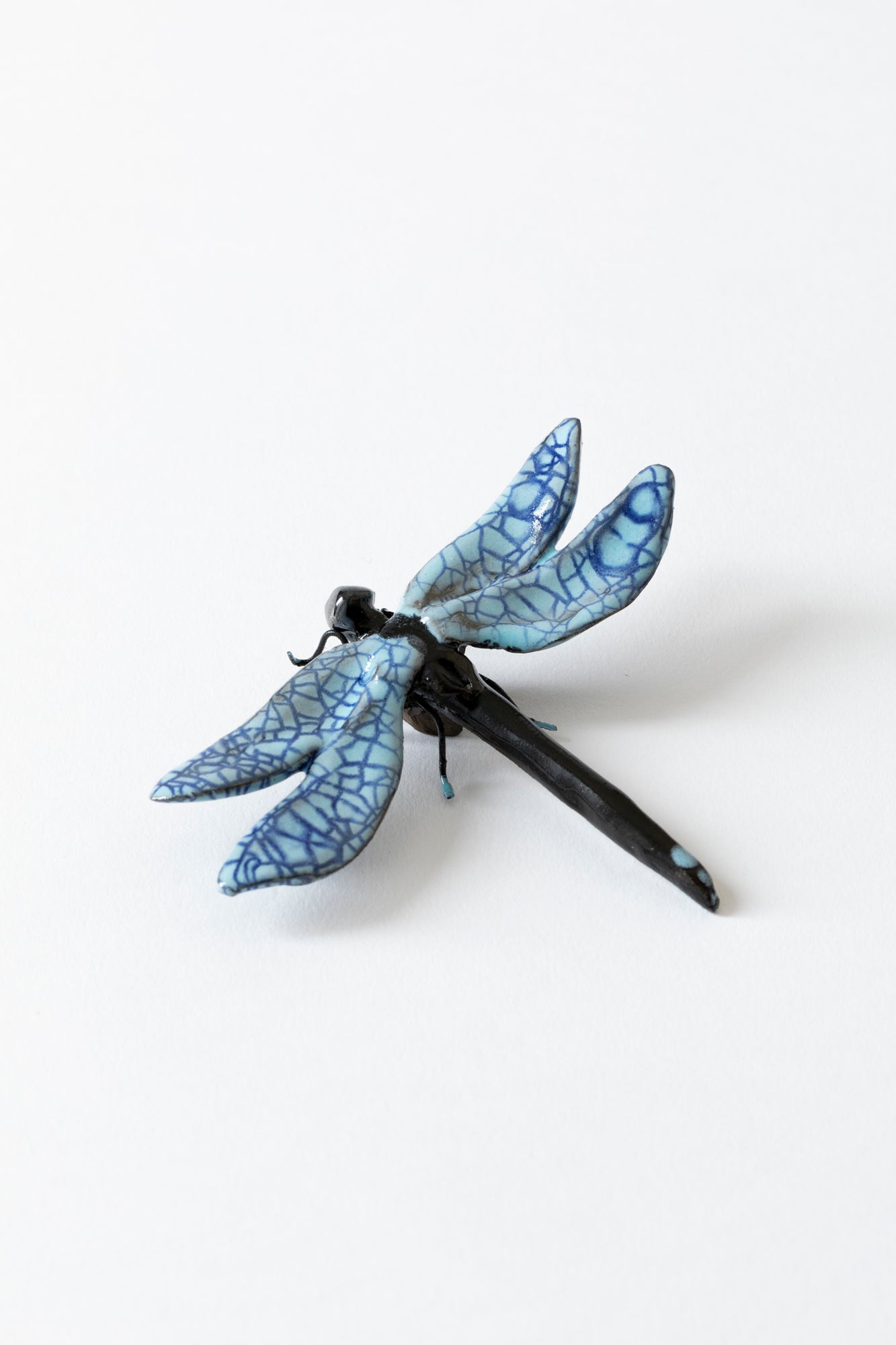 Handmade ceramic insects in various shapes, glazes, and guises.