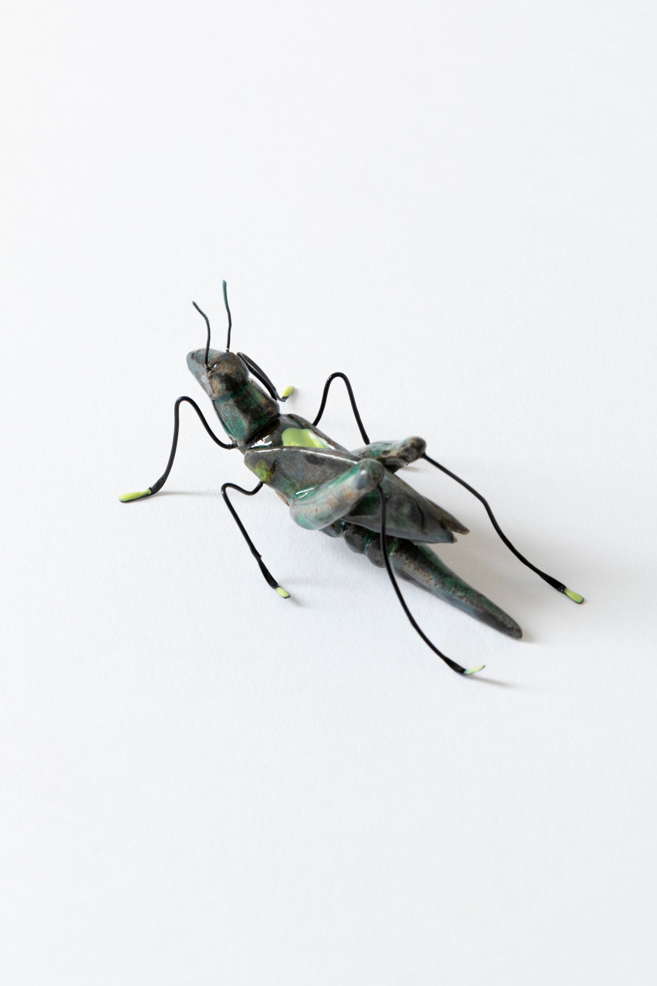 Handmade ceramic insects in various shapes, glazes, and guises.