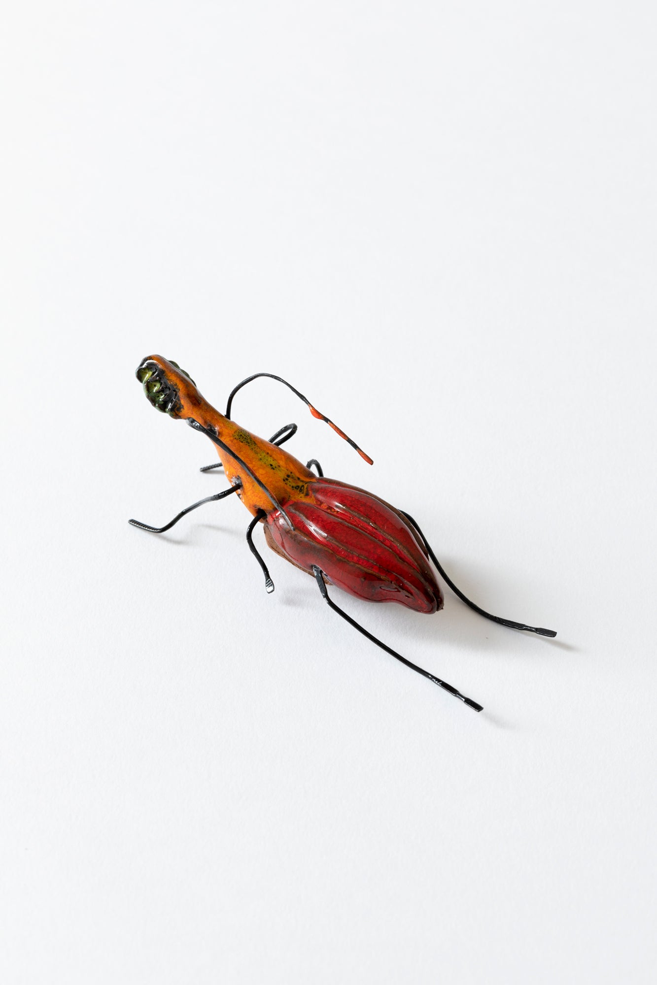 Handmade ceramic insects in various shapes, glazes, and guises.