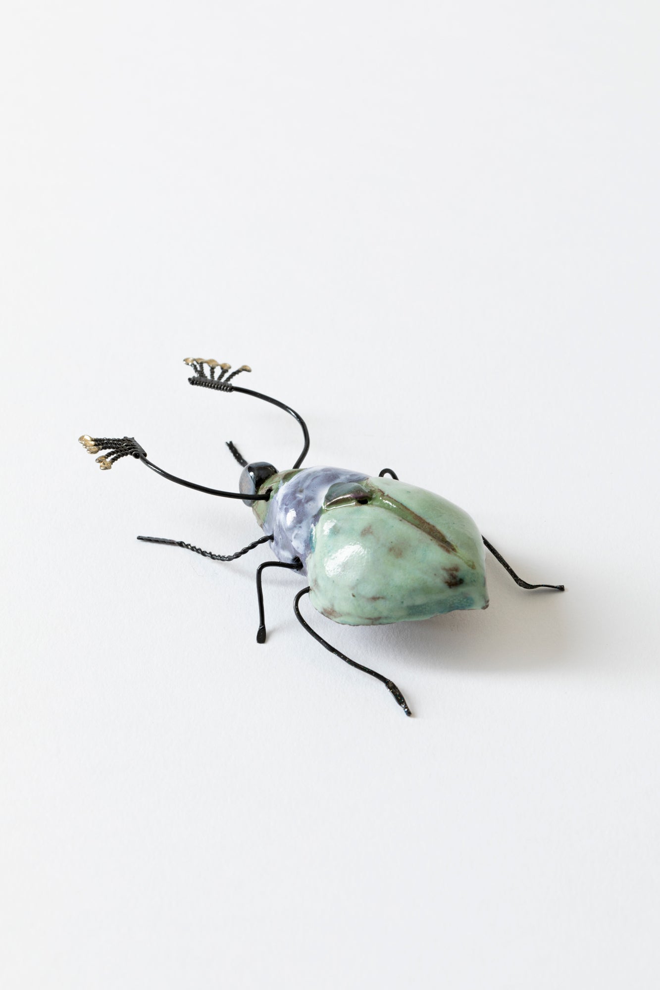 Handmade ceramic insects in various shapes, glazes, and guises.