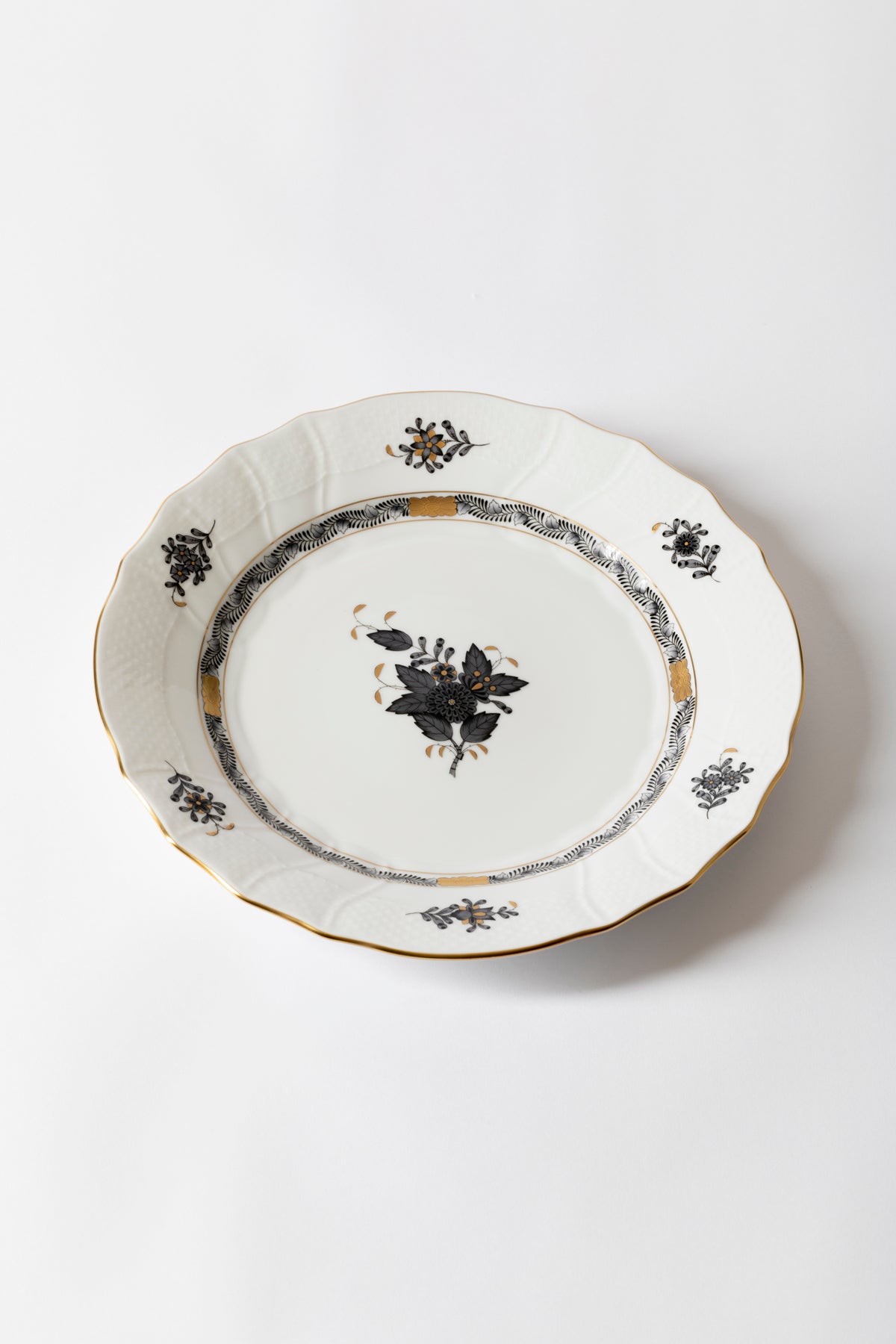 Five piece dinner service is hand painted on white porcelain including 24k accents. Black details.