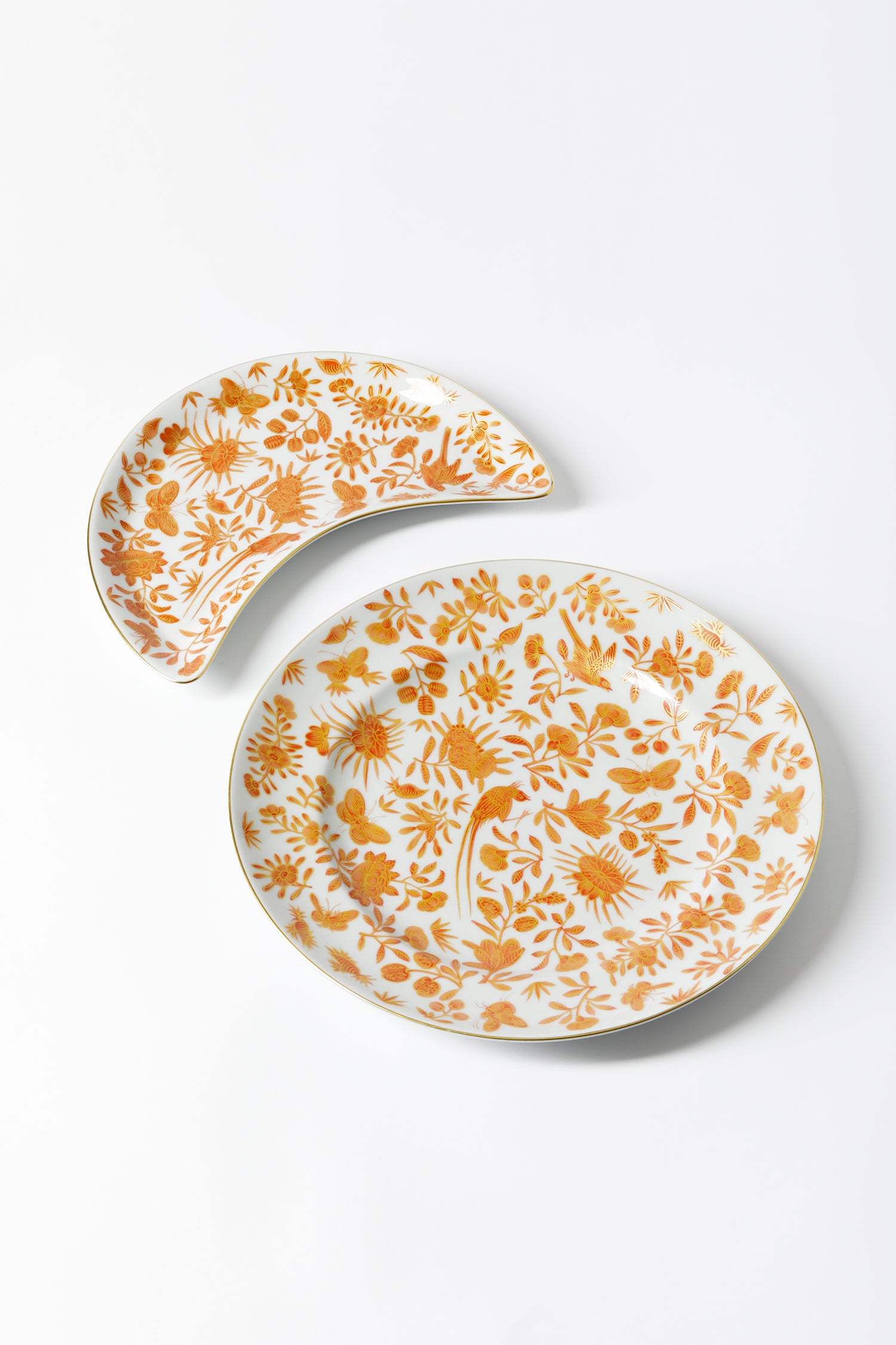 Sacred birds in orange print. Five piece place setting includes dinner plate, dessert plate, bread & butter plate and teacup with saucer.