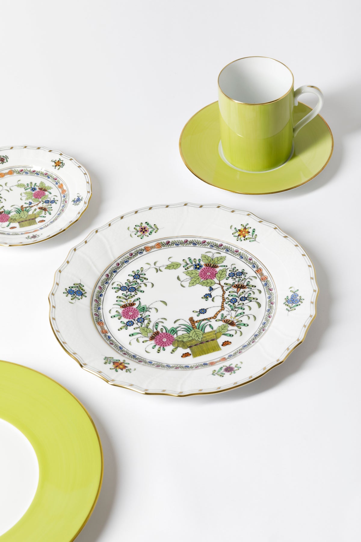 Porcelain dinnerware that has rich colors in an exotic pattern that stand alone with a solid cloth or add strong layers to a Bohemian look.
