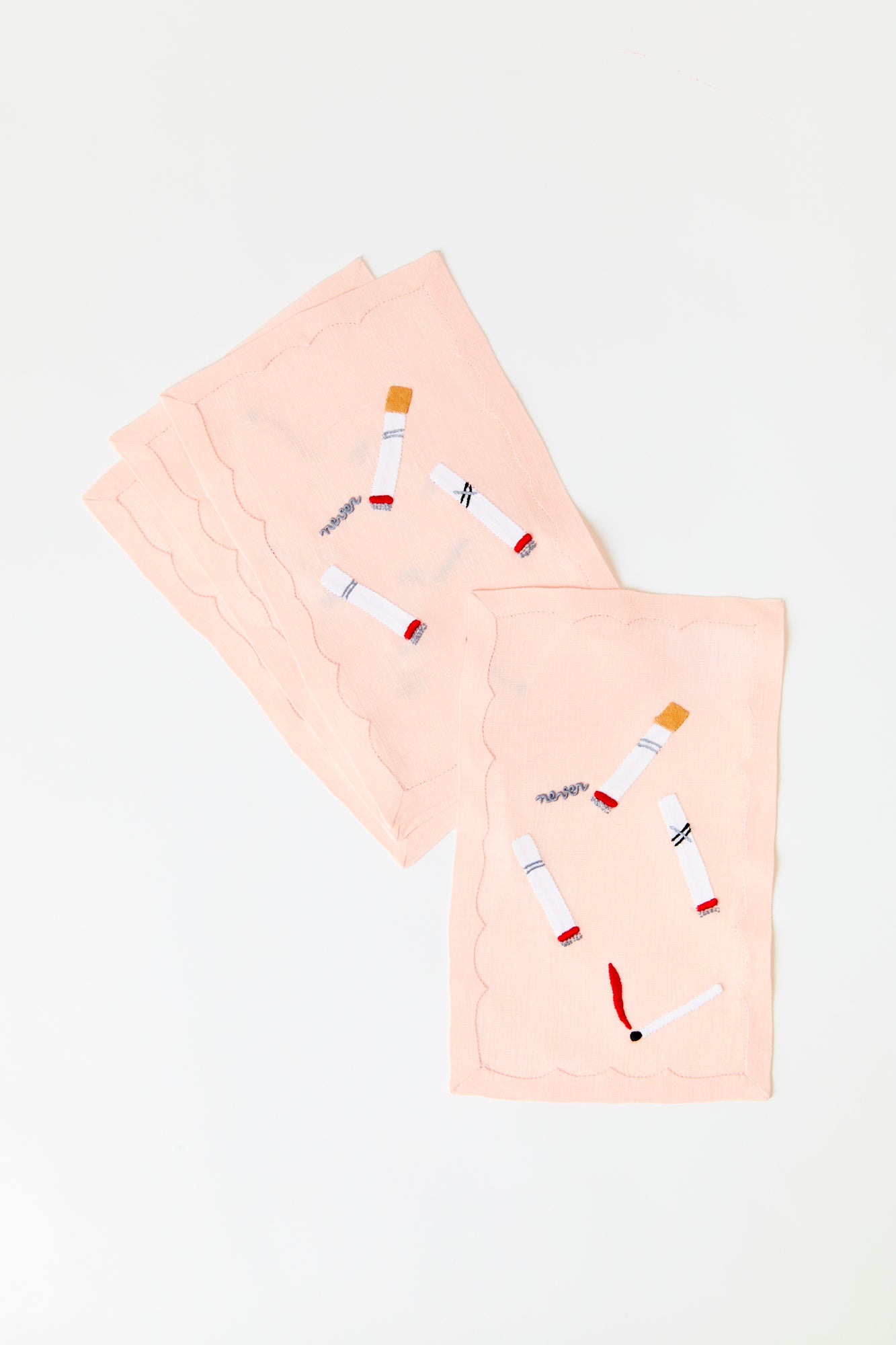 Cocktail napkins with cigarette embroidery.
