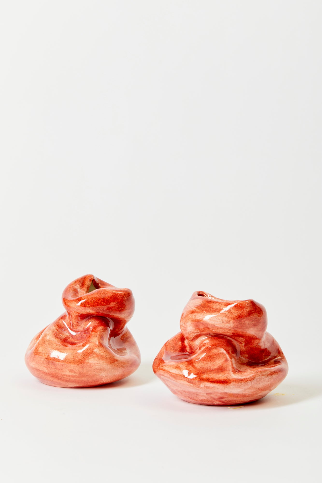 Small red ceramic bud vases.