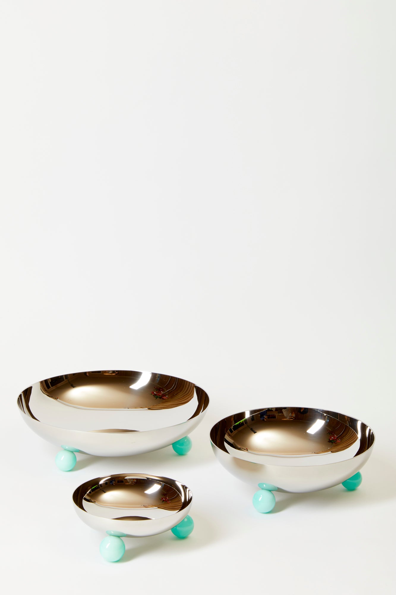 Spherical feet in amazonite green hoist a stainless steel vessel begging for Postmodern bites.