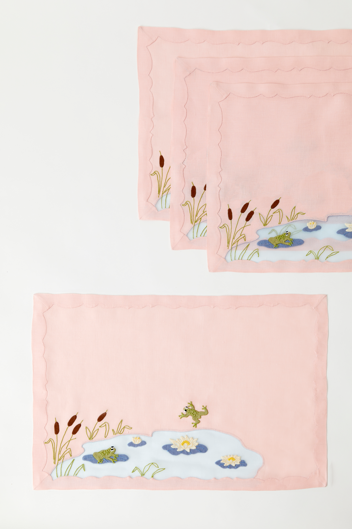 Frog in a pond placemat and dinner napkins feature French stitch appliqué made in Madeira, Portugal.