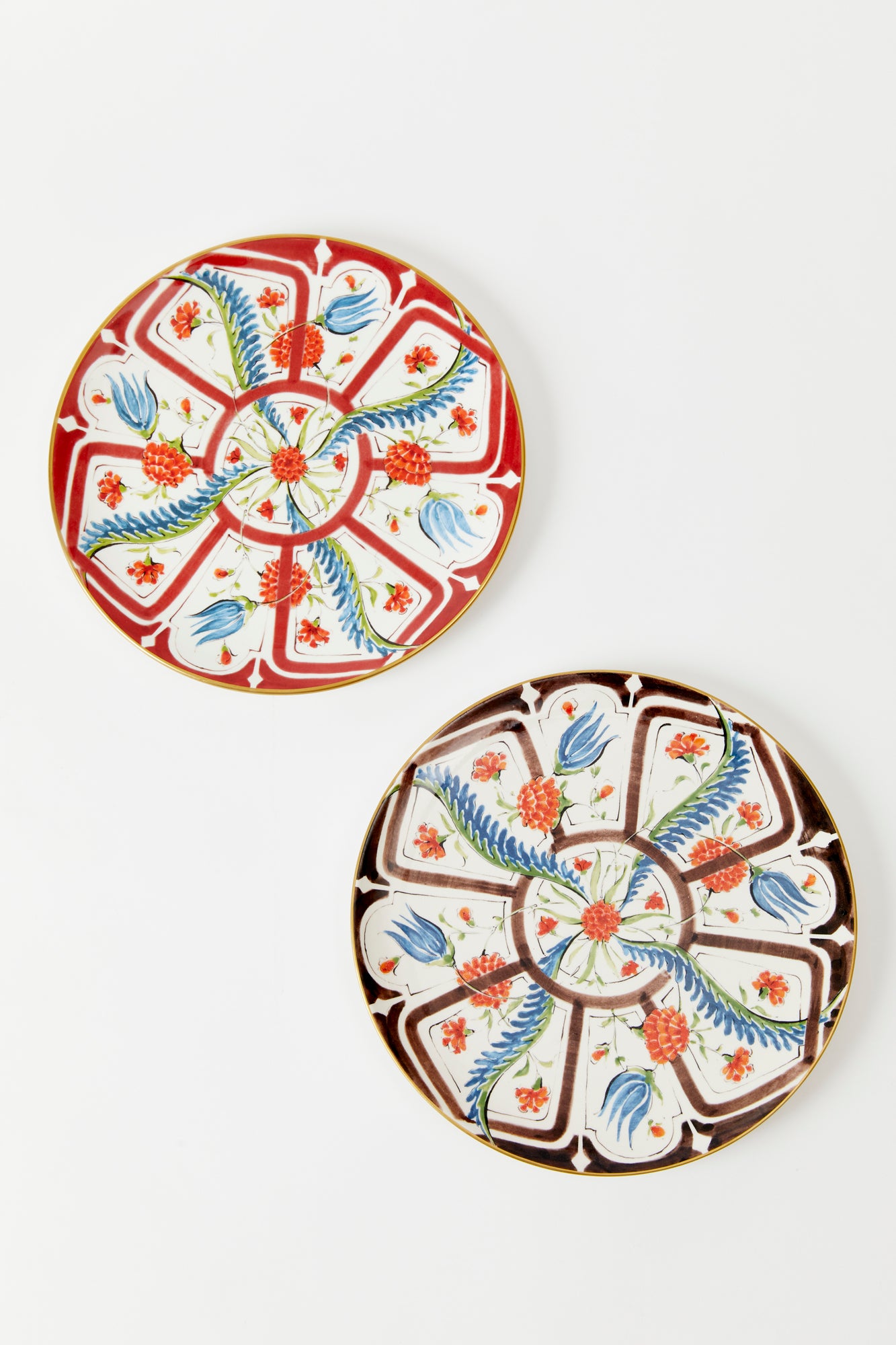 Earthenware plates with a glost-fired Iznik pattern of tropical flowers, designed and hand-painted by a family of artisans in historic Milan. 
