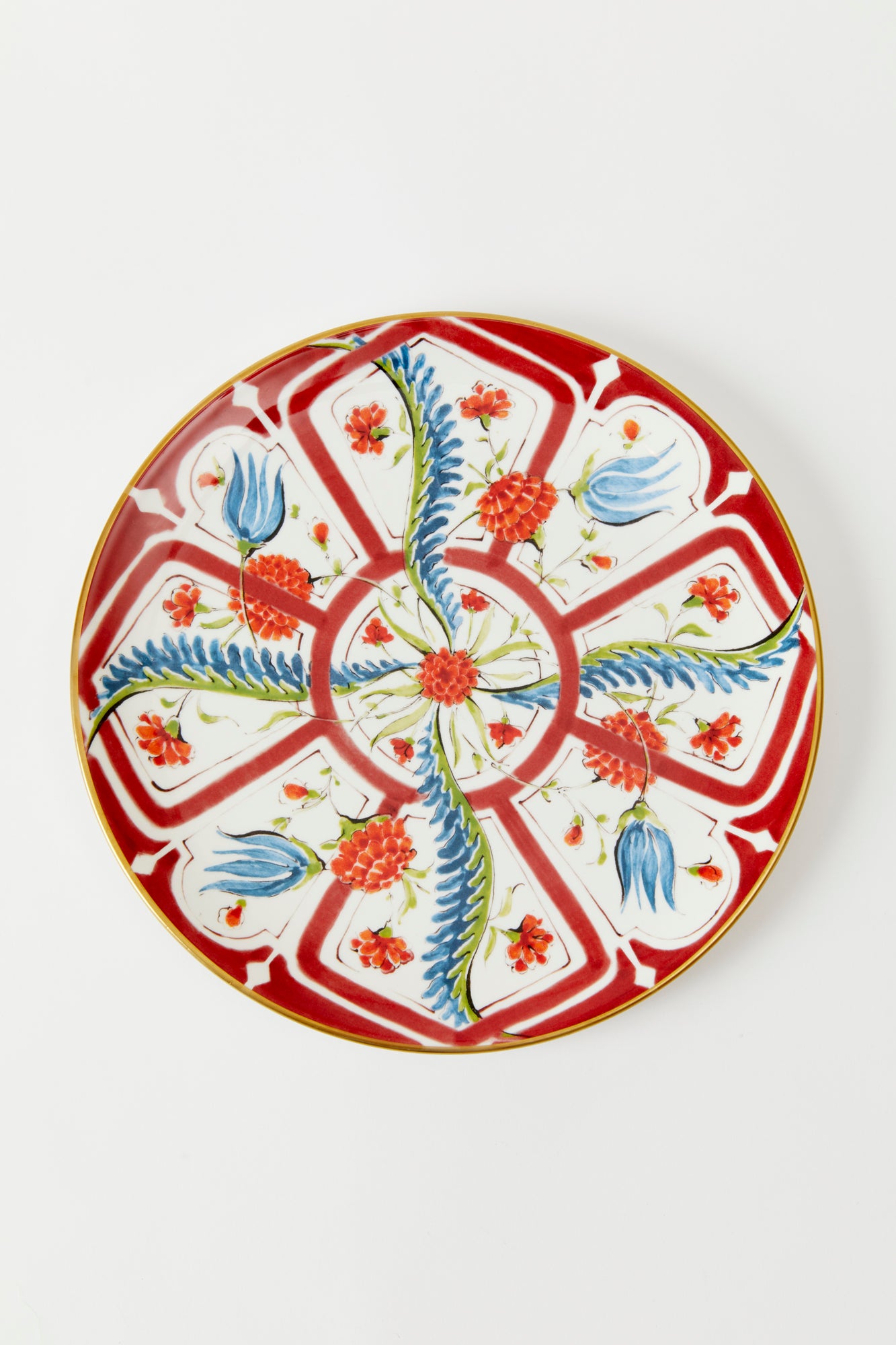 Earthenware plates with a glost-fired Iznik pattern of tropical flowers, designed and hand-painted by a family of artisans in historic Milan.
